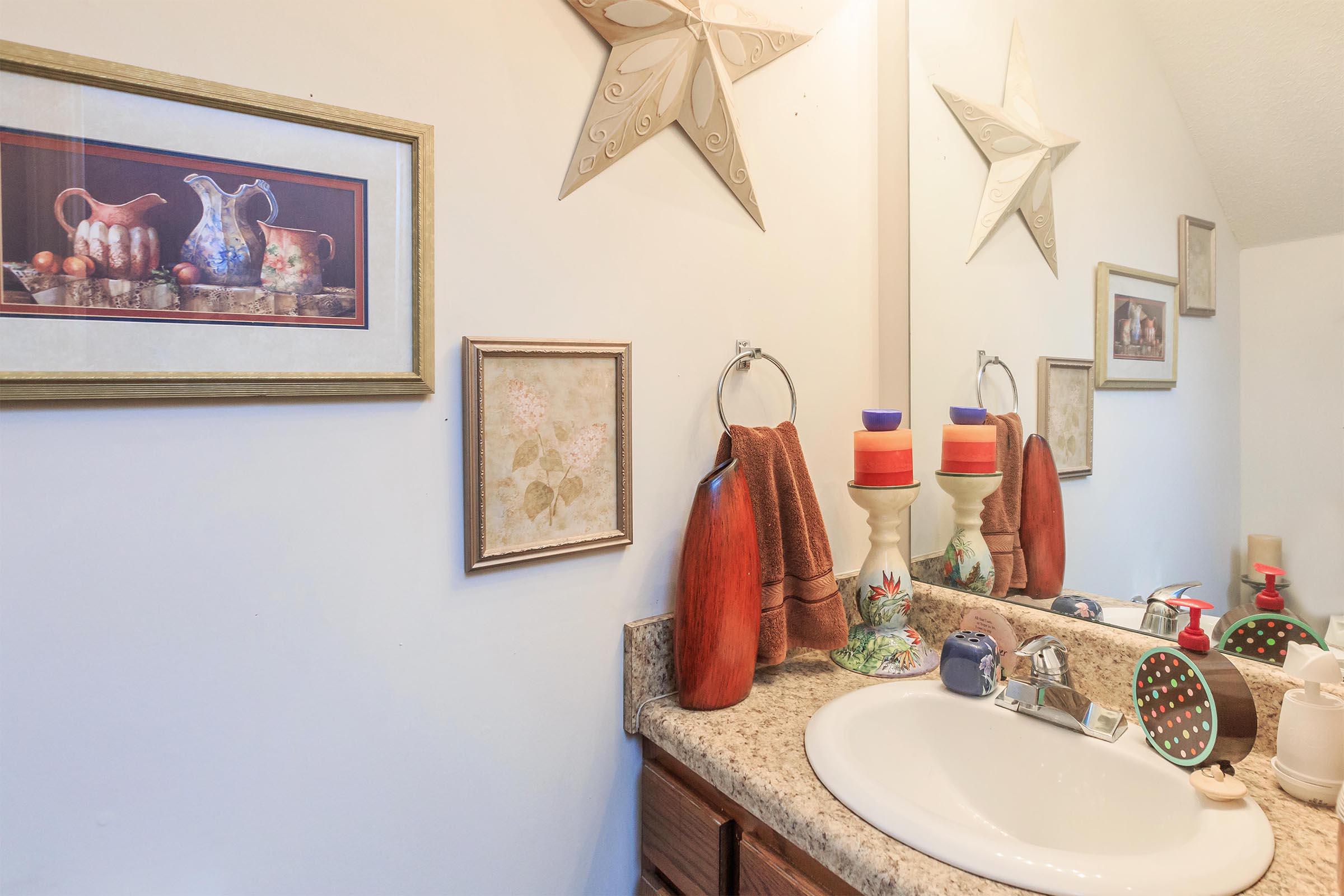 a room with a sink and a mirror
