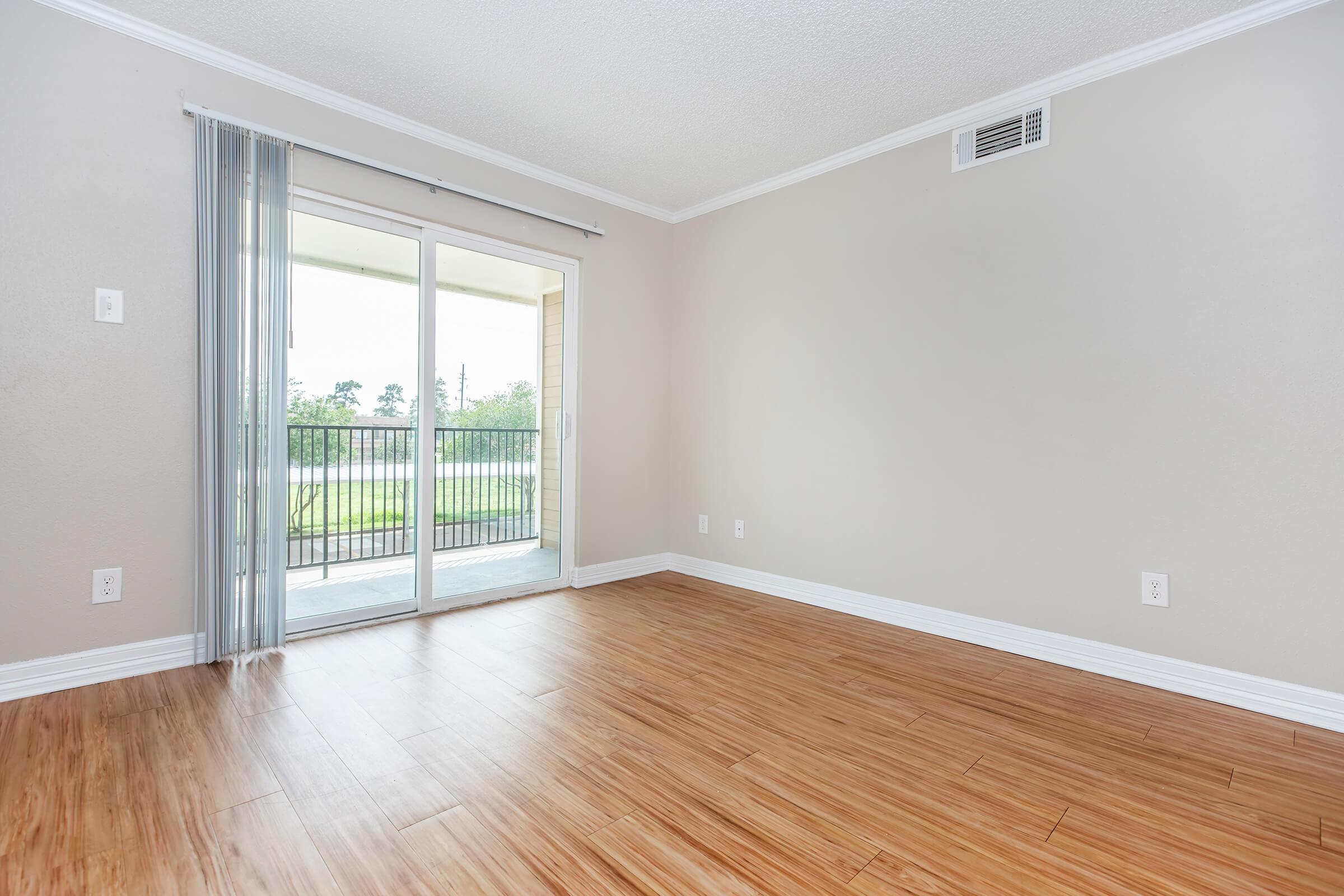 a close up of a hard wood floor next to a window