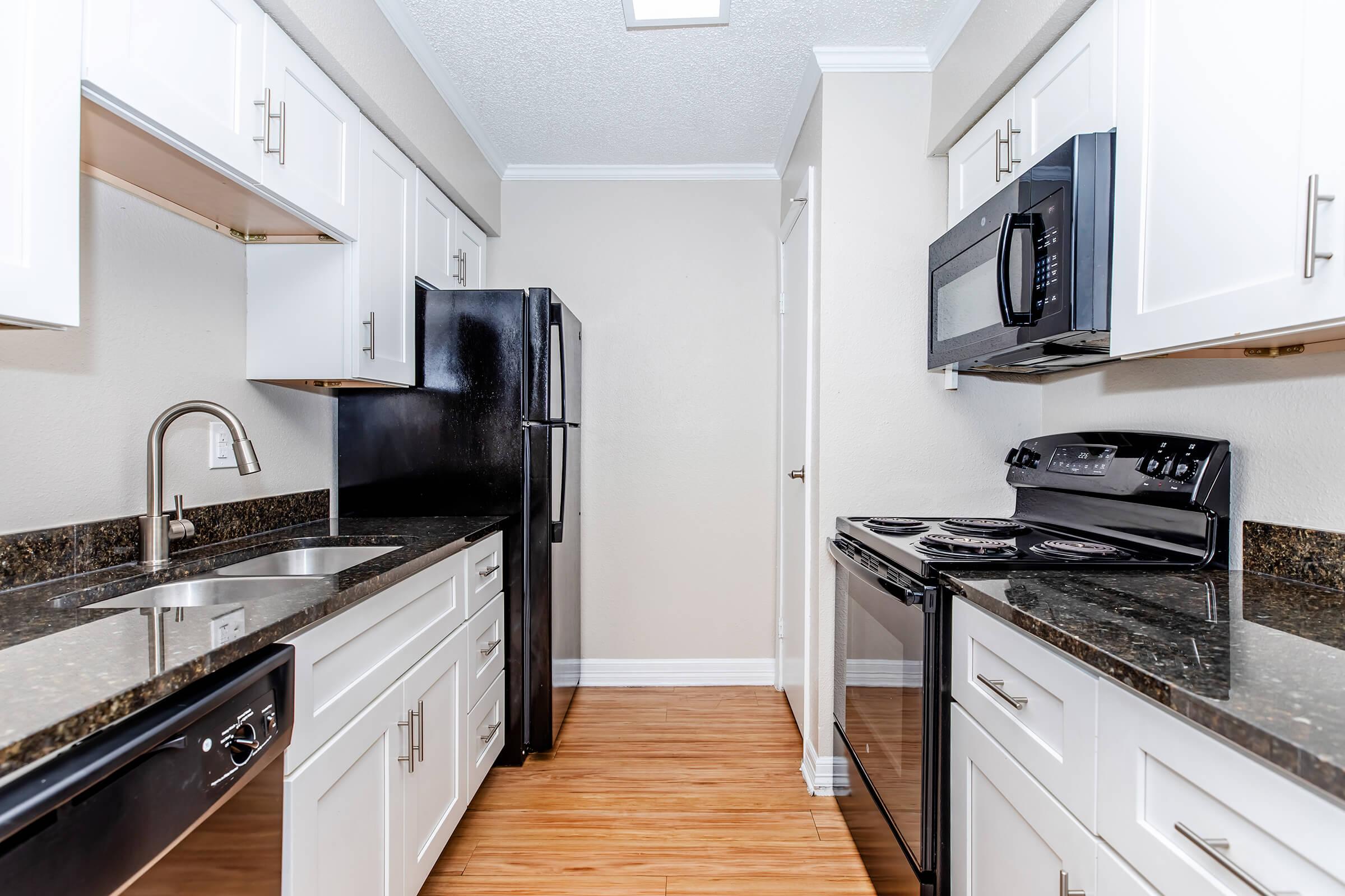 a modern kitchen with stainless steel appliances and wooden cabinets