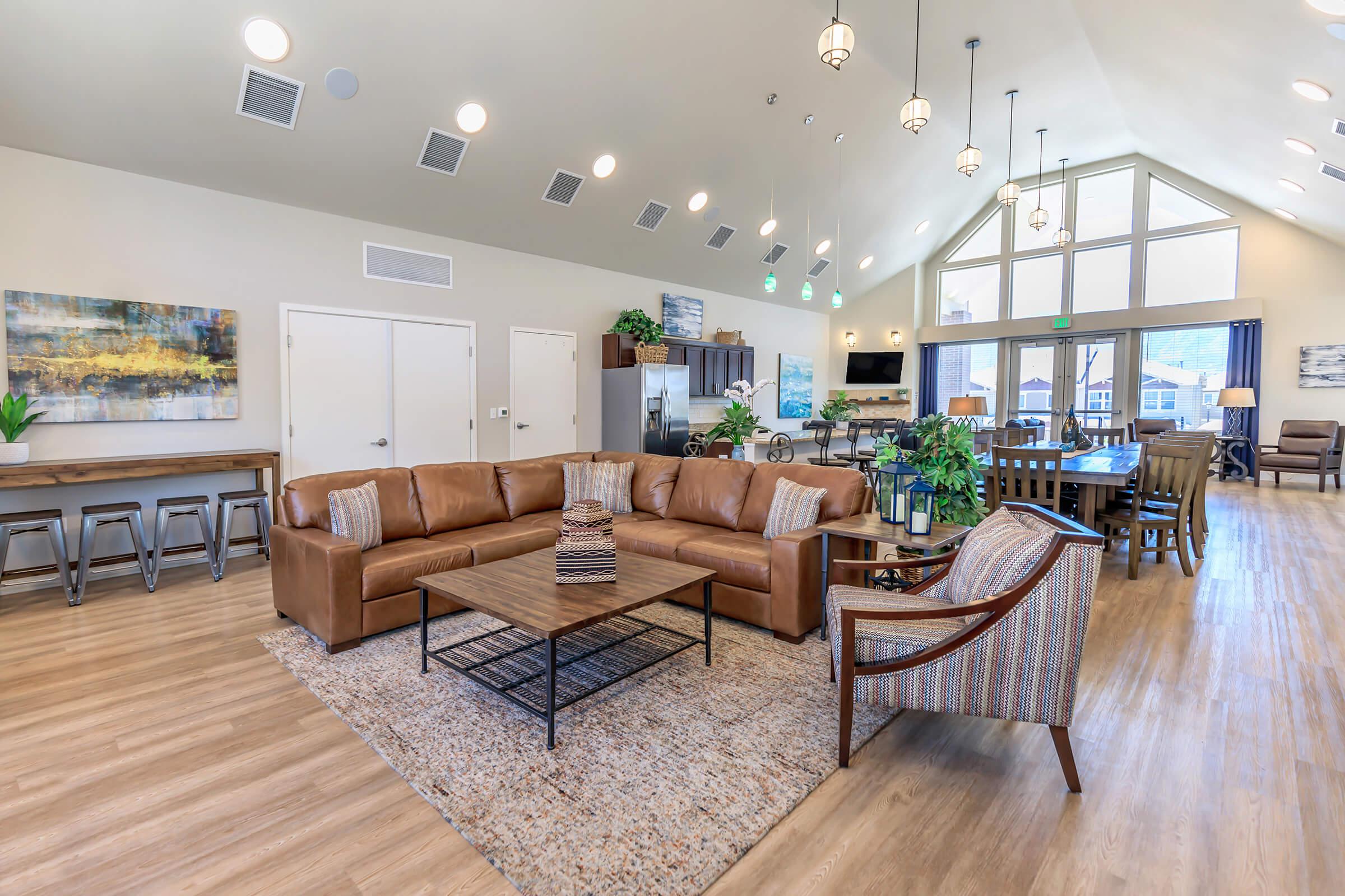 a living room filled with furniture and a wood floor