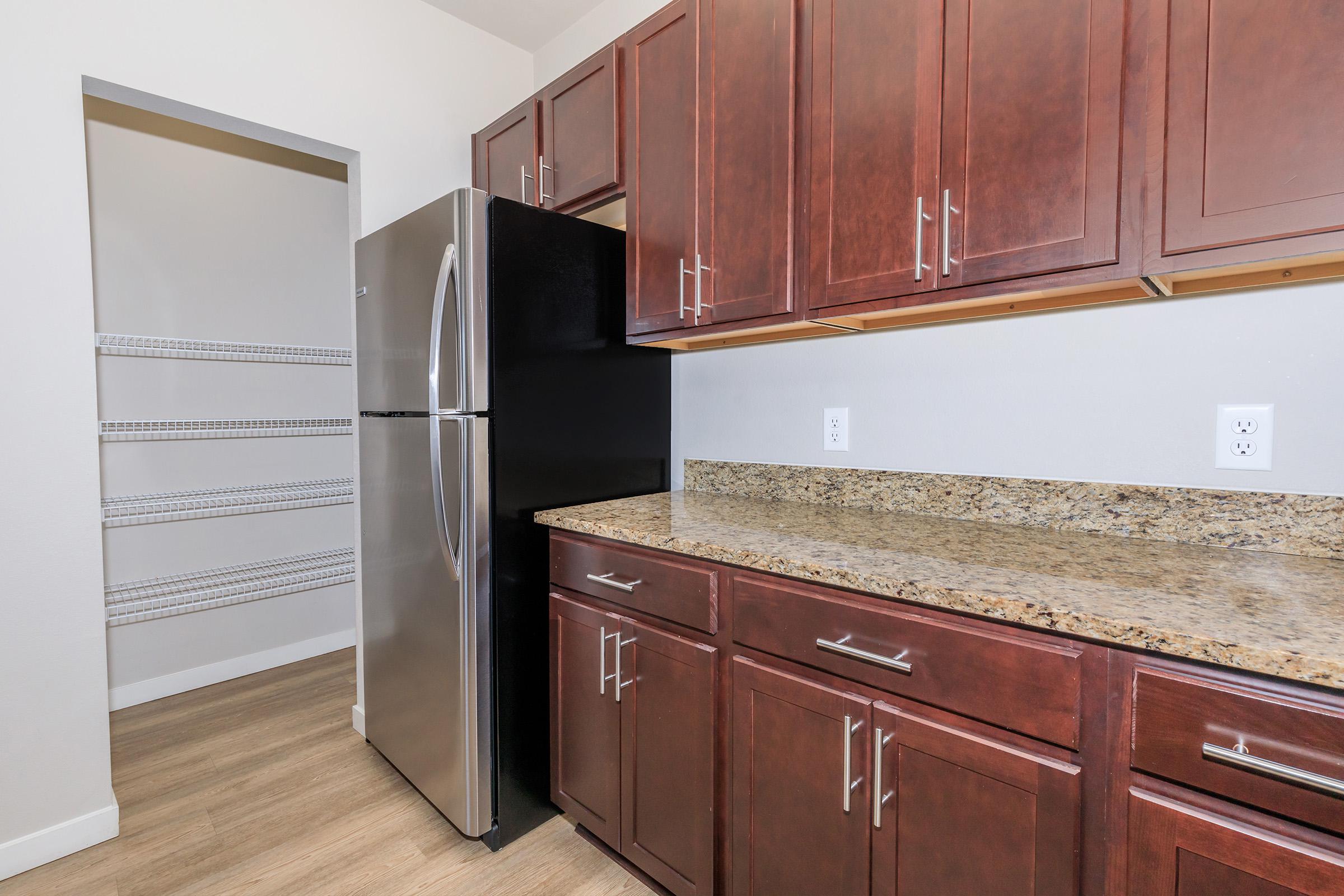 a kitchen with stainless steel appliances and wooden cabinets