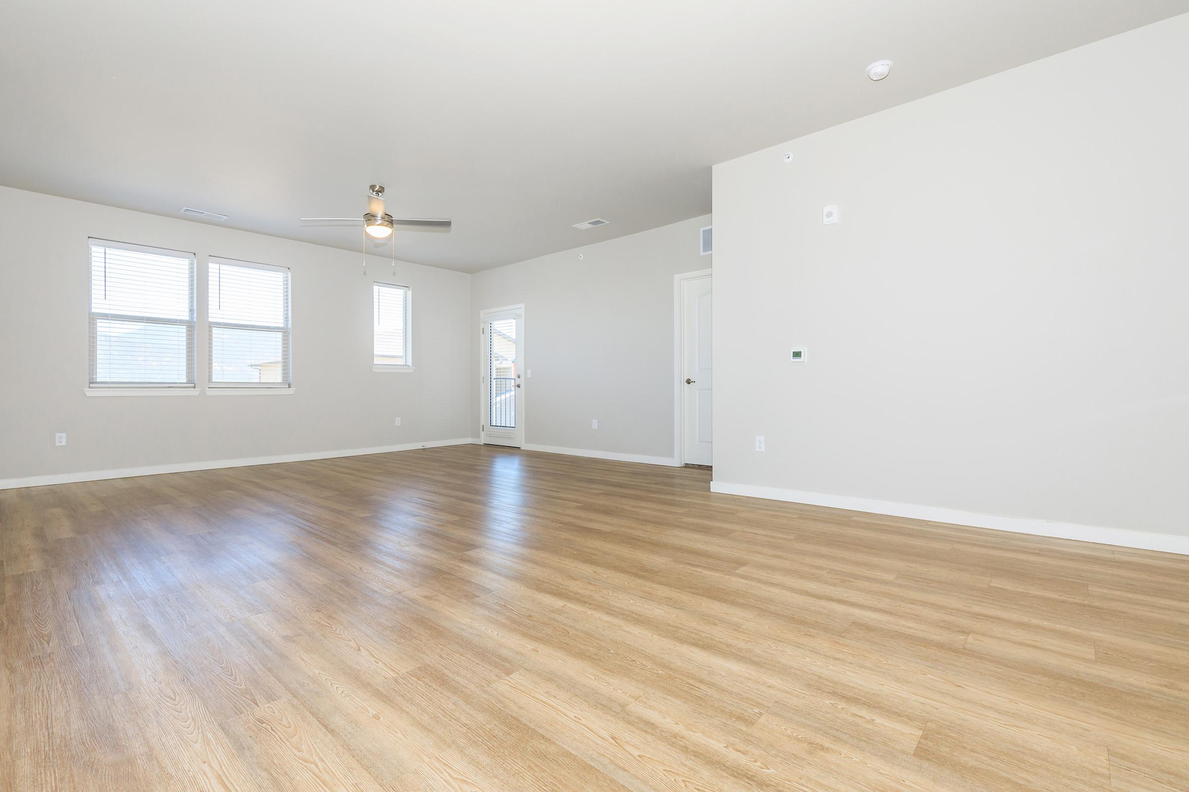 a large empty room with a wooden floor