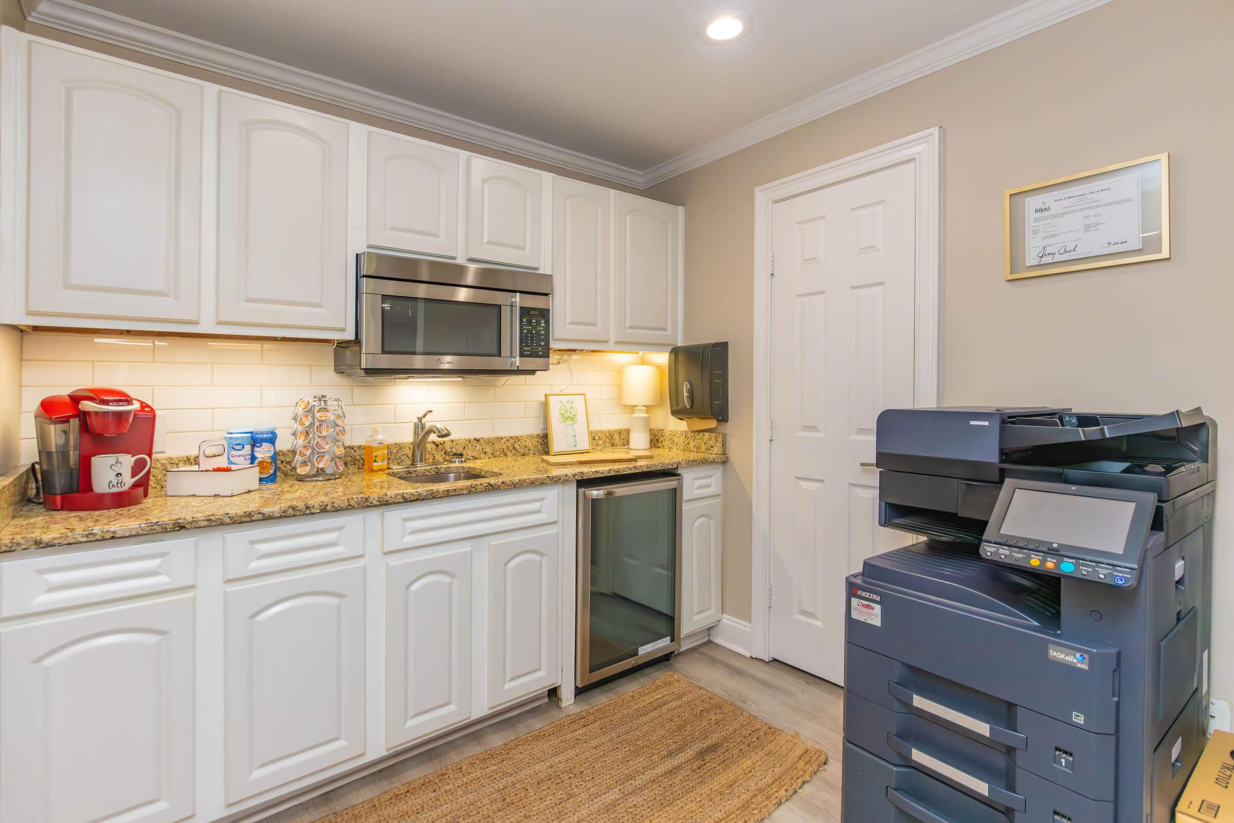 a stove top oven sitting inside of a kitchen