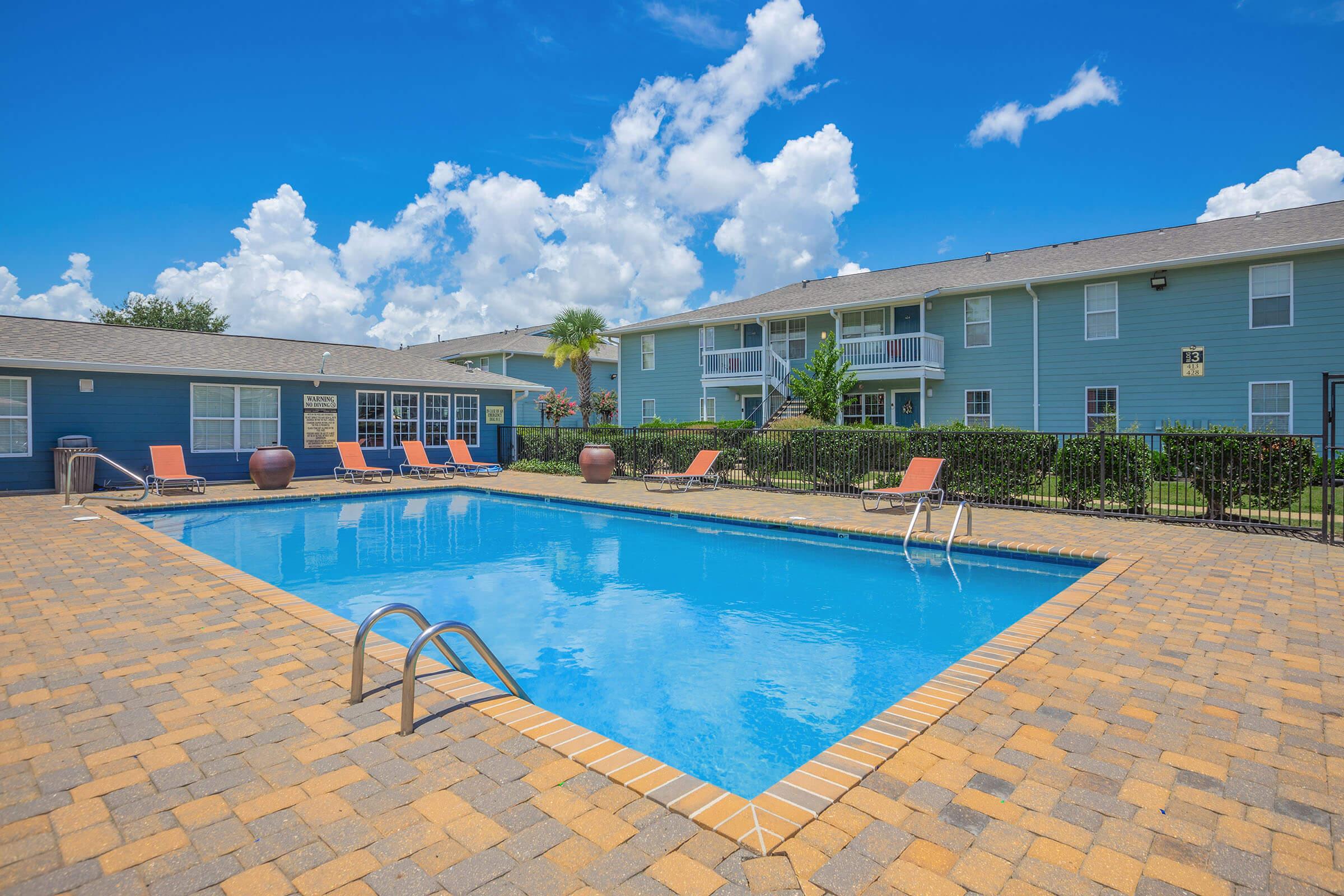 a pool next to a brick building