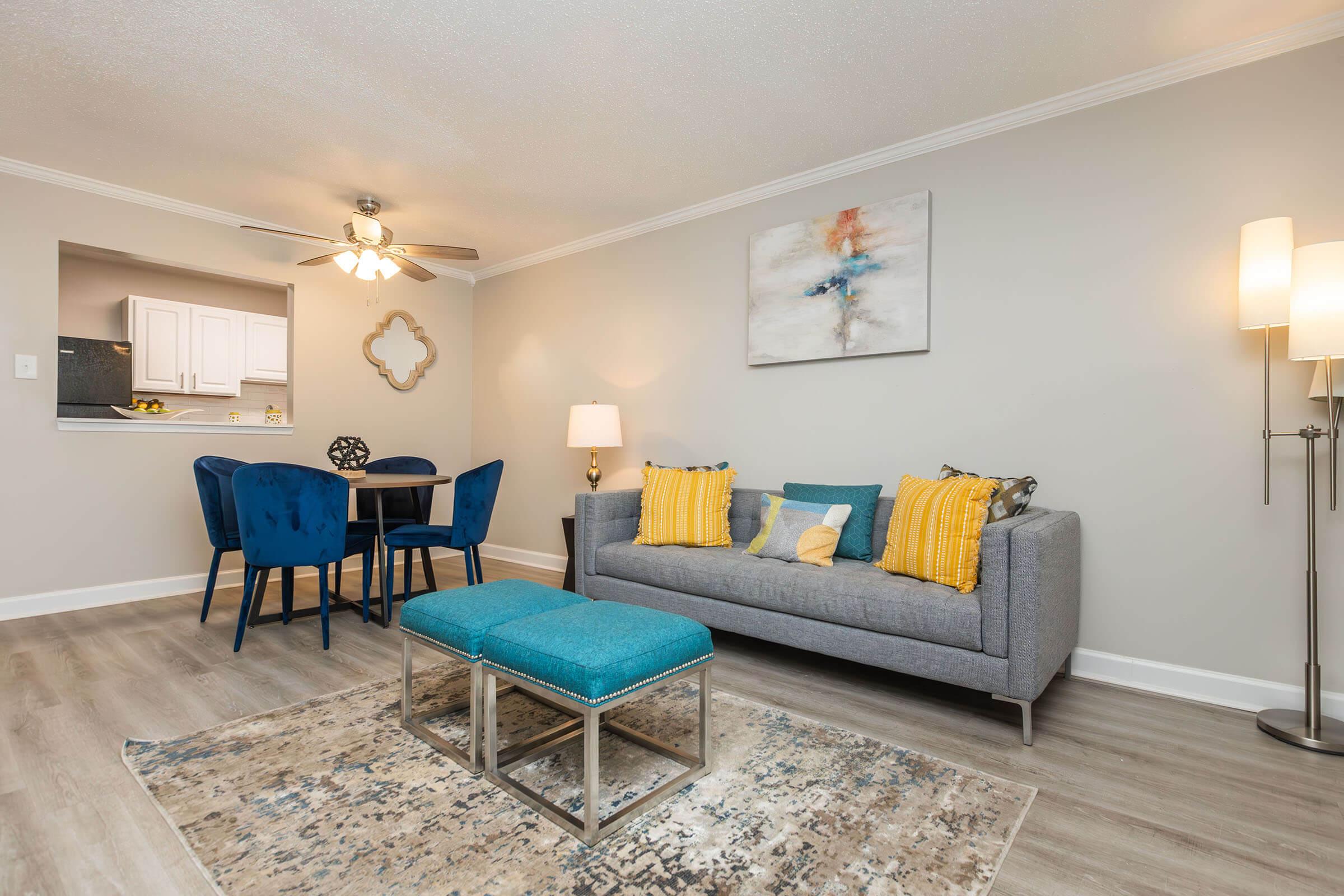 a living room filled with furniture and a lamp