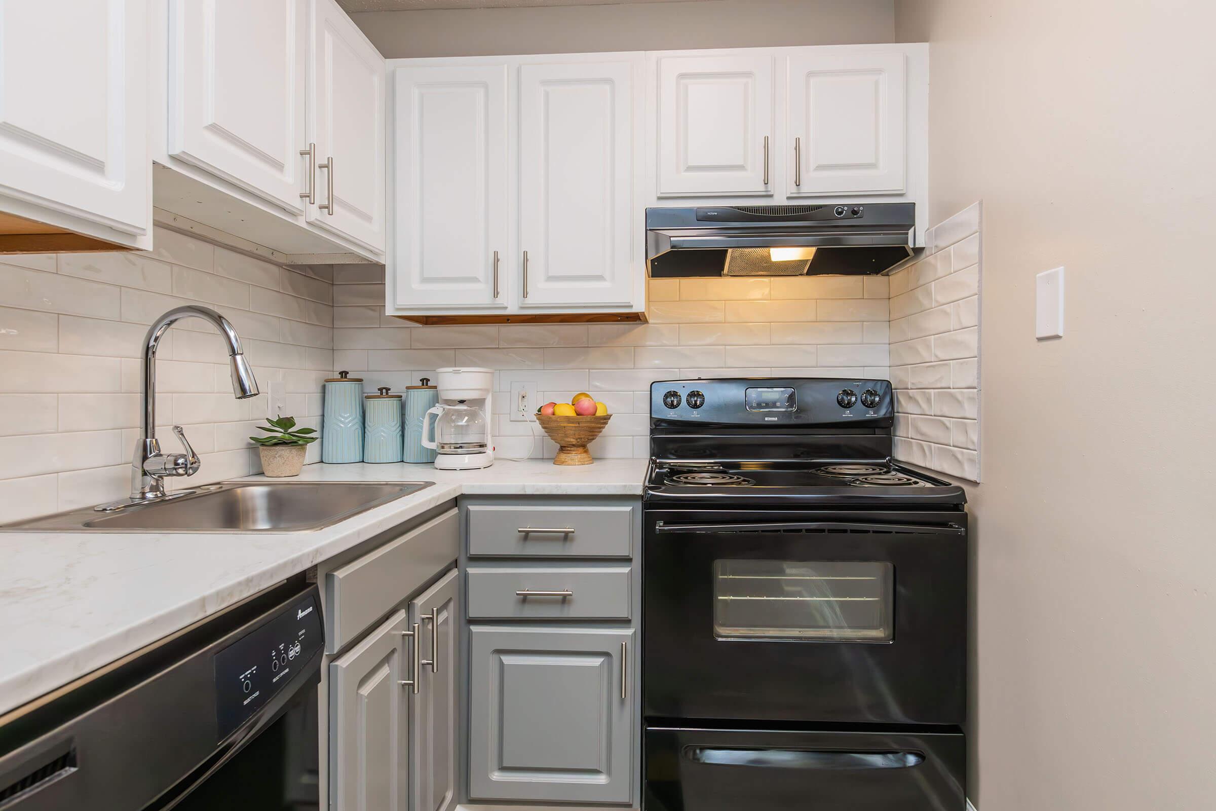 a stove top oven sitting inside of a kitchen