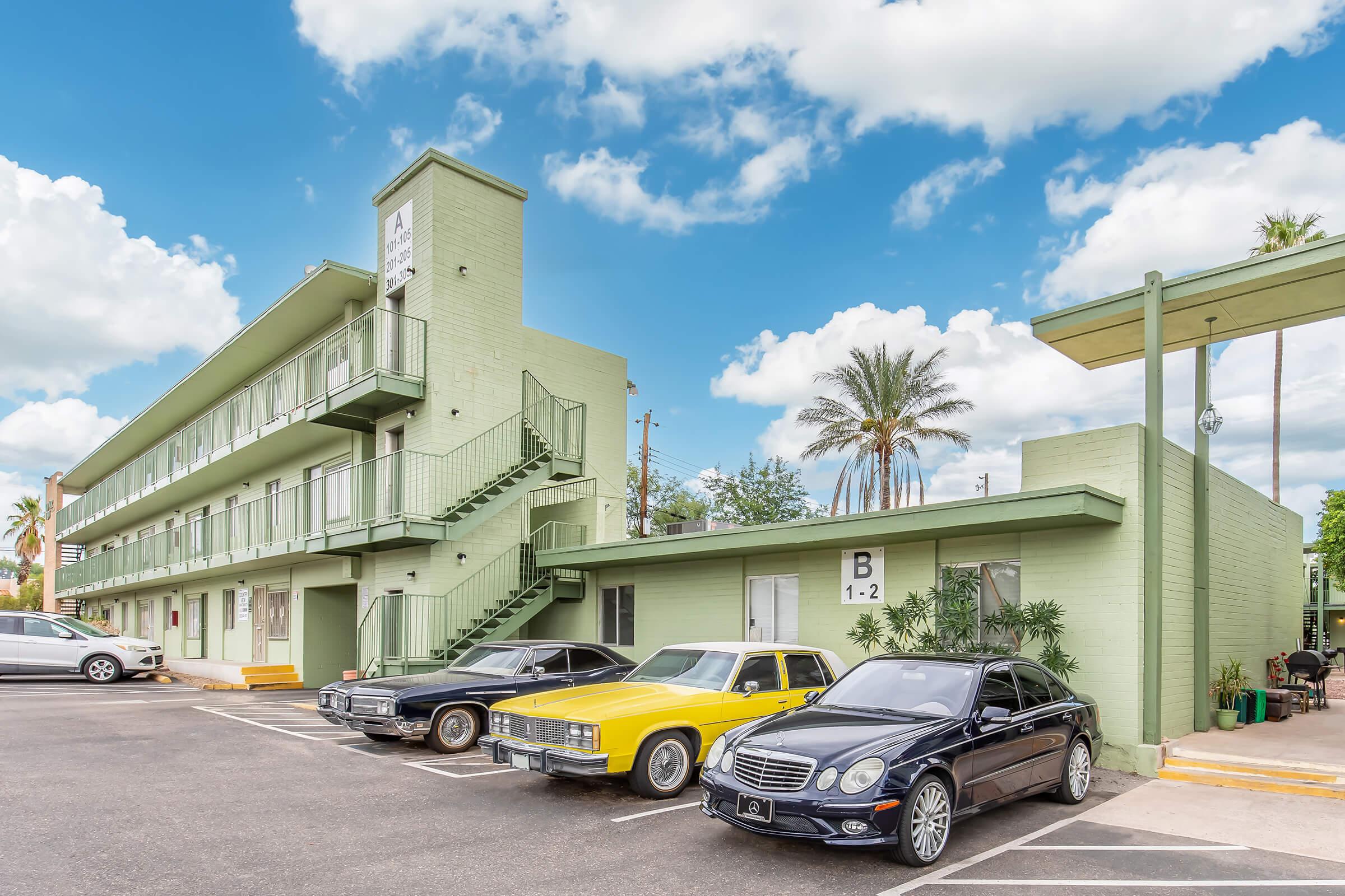 a car parked in a parking lot in front of a building