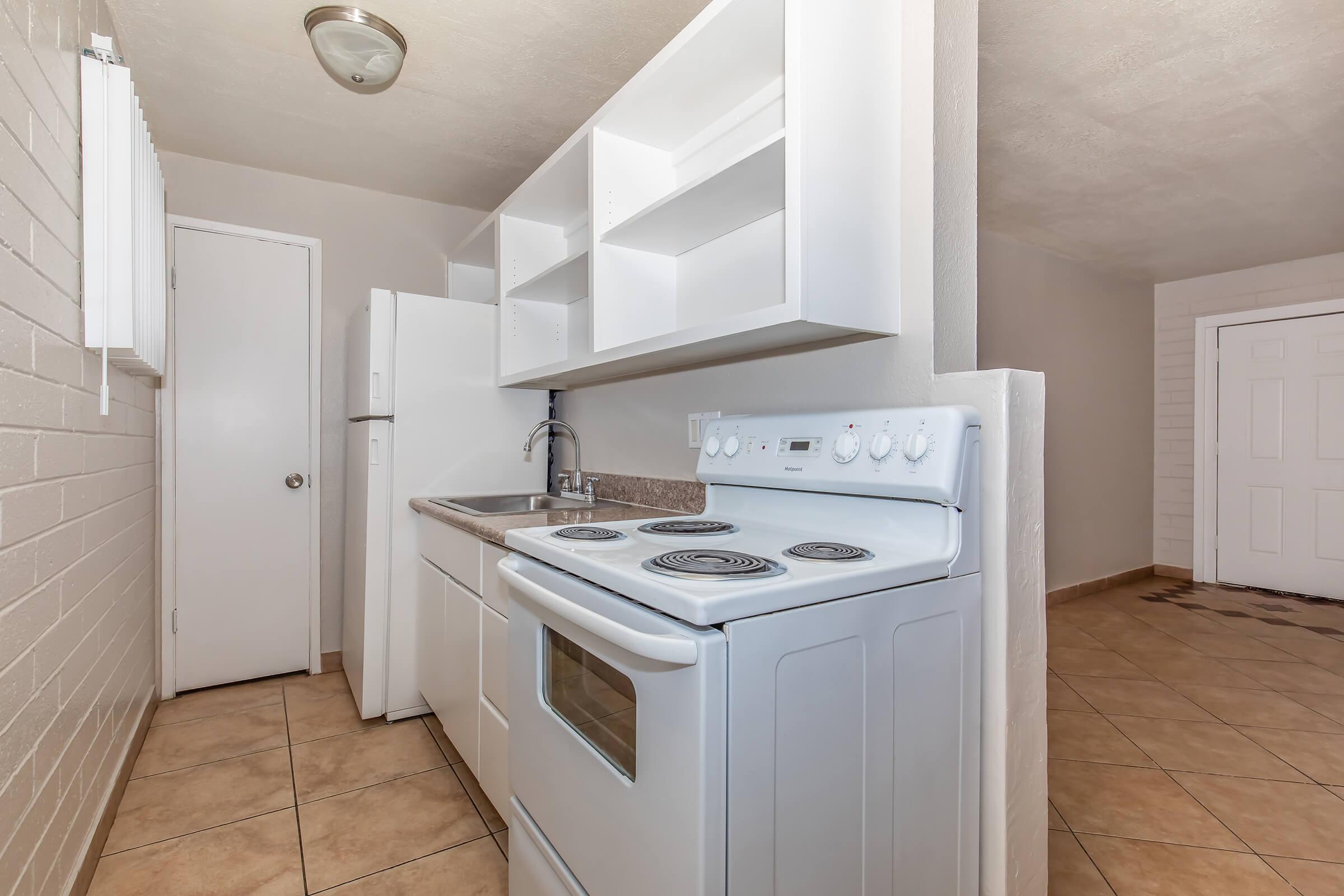 a kitchen with a stove top oven sitting inside of a building