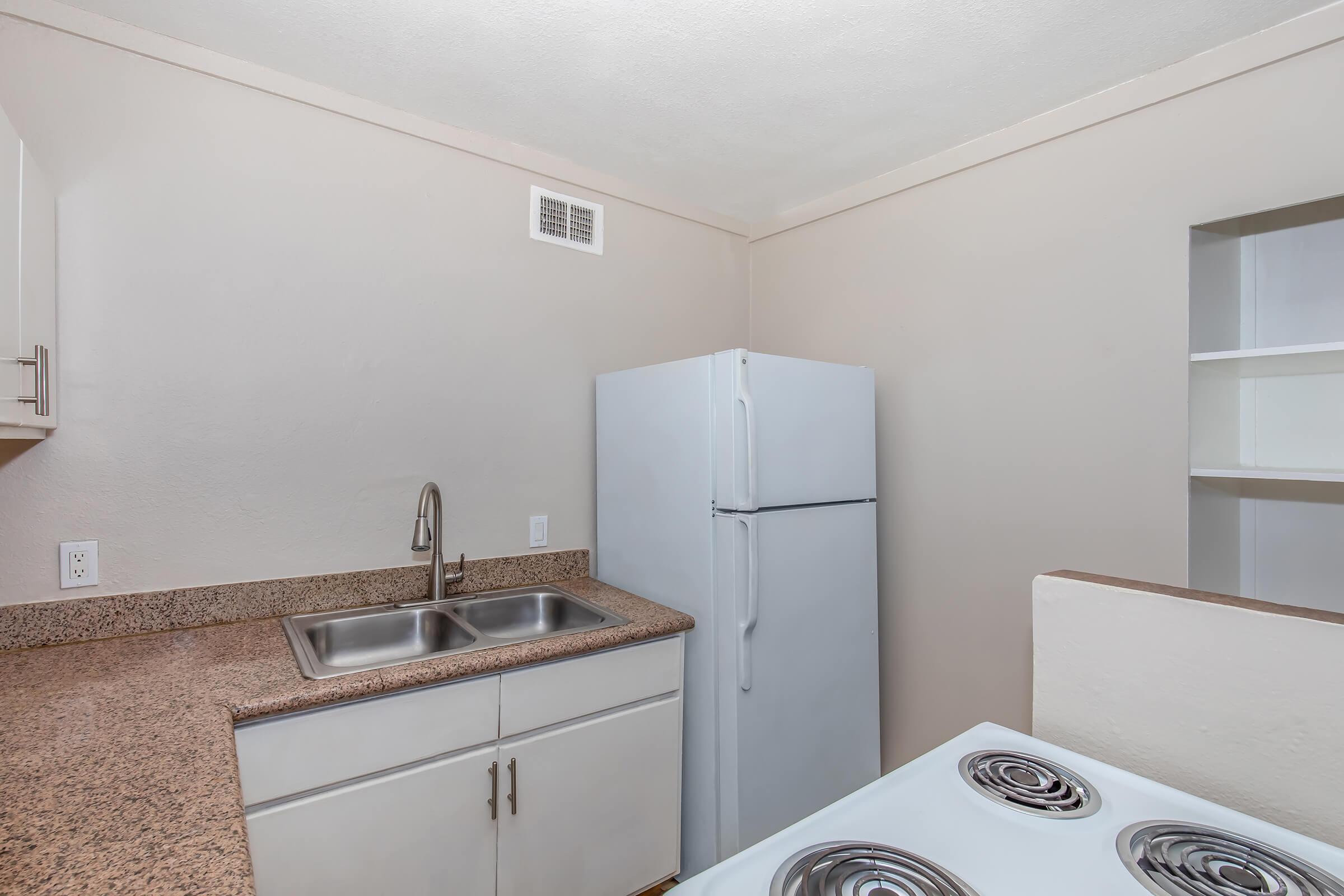 a kitchen with a sink and a mirror