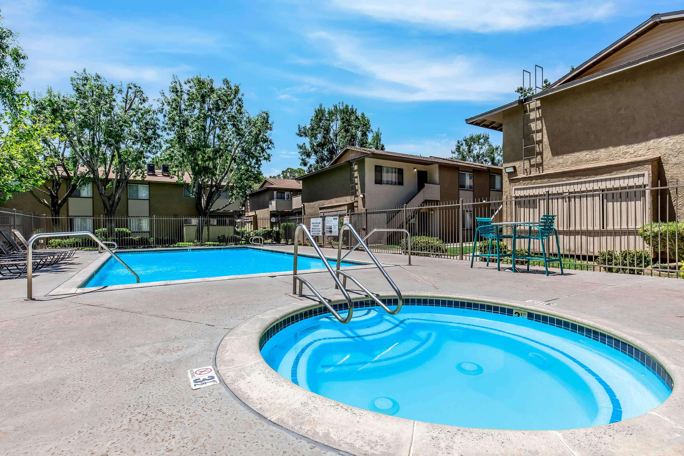 a blue pool of water in front of a building