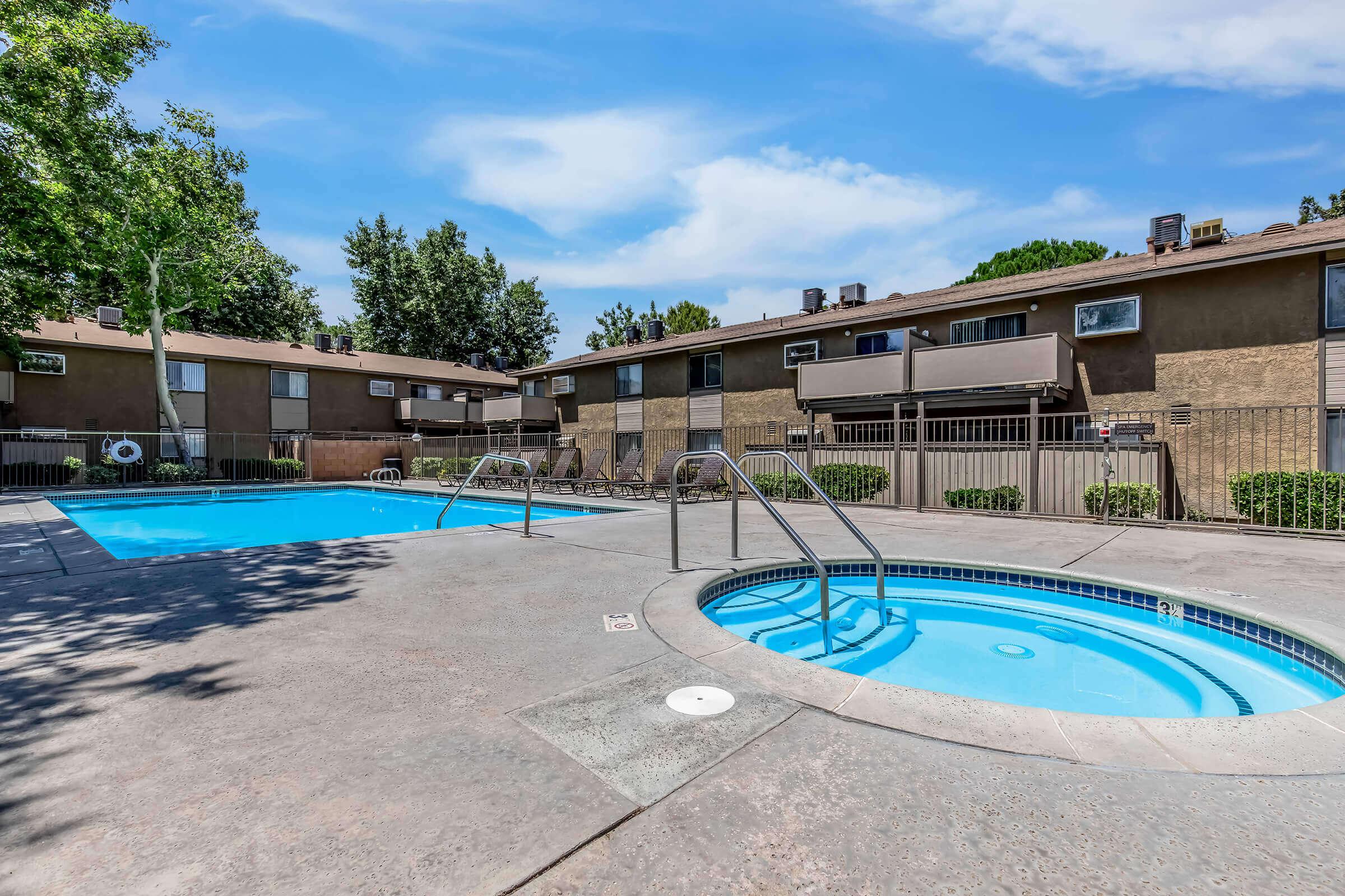 Apartments in Lancaster, CA - Sienna Heights - Swimming Pool with a Spa, Lounge Chairs, and Beautiful Landscaping