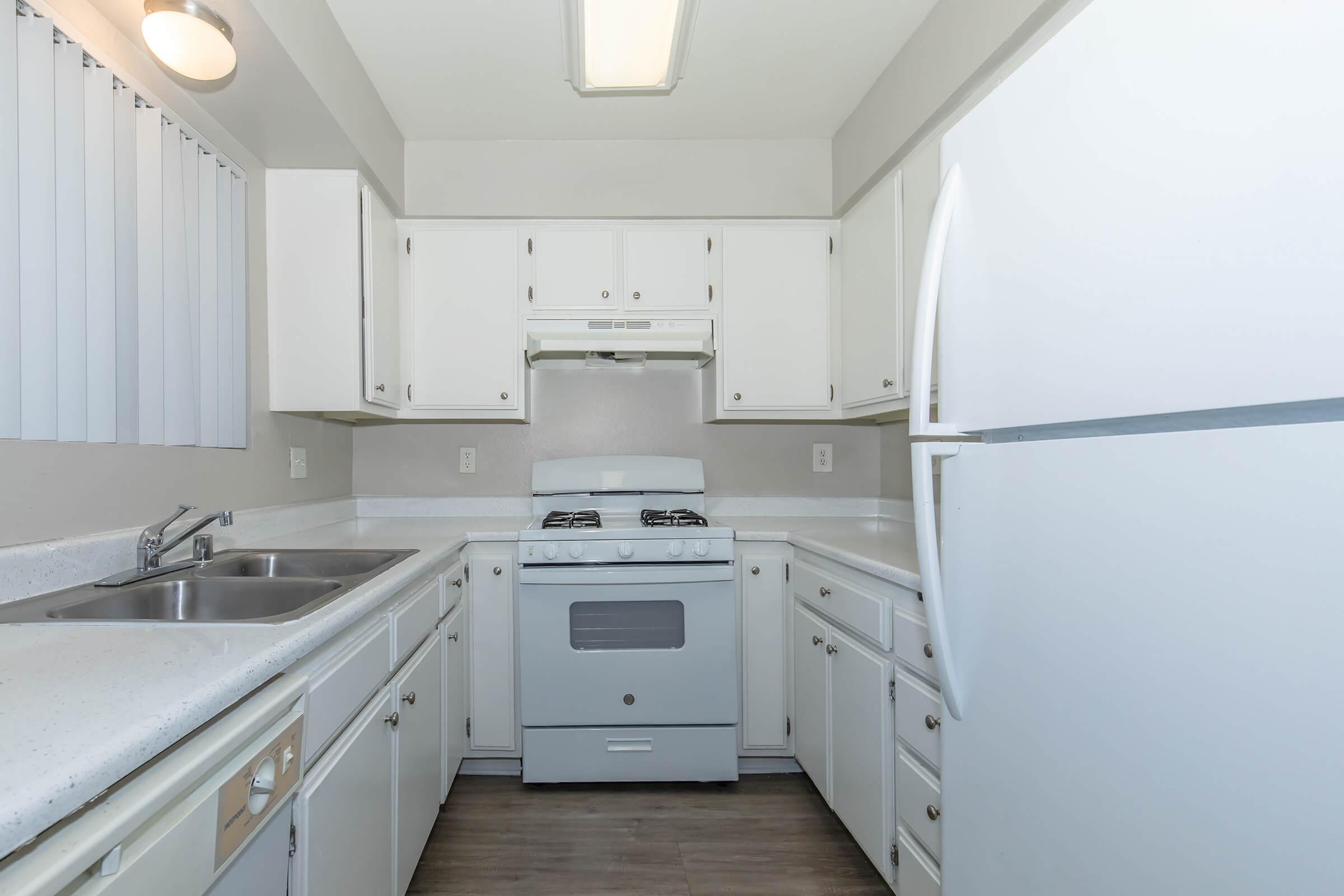 a stove top oven sitting inside of a kitchen