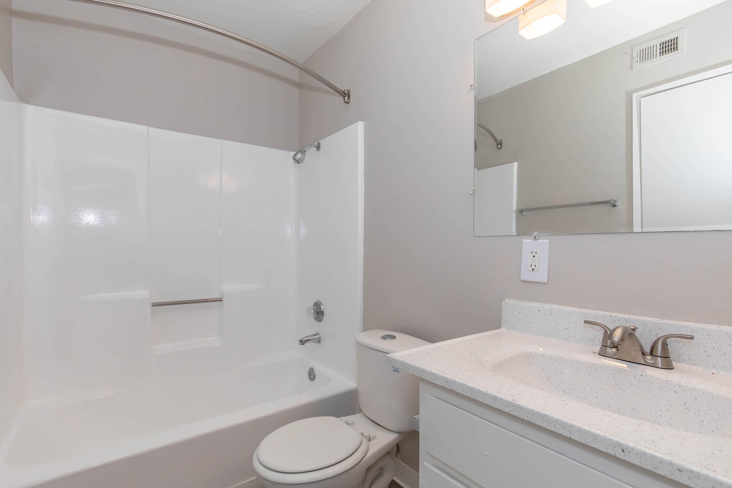 Lancaster, CA Apartments for Rent - Sienna Heights - Bathroom with a Garden-Style Tub, a Vanity, and Granite-Style Countertop