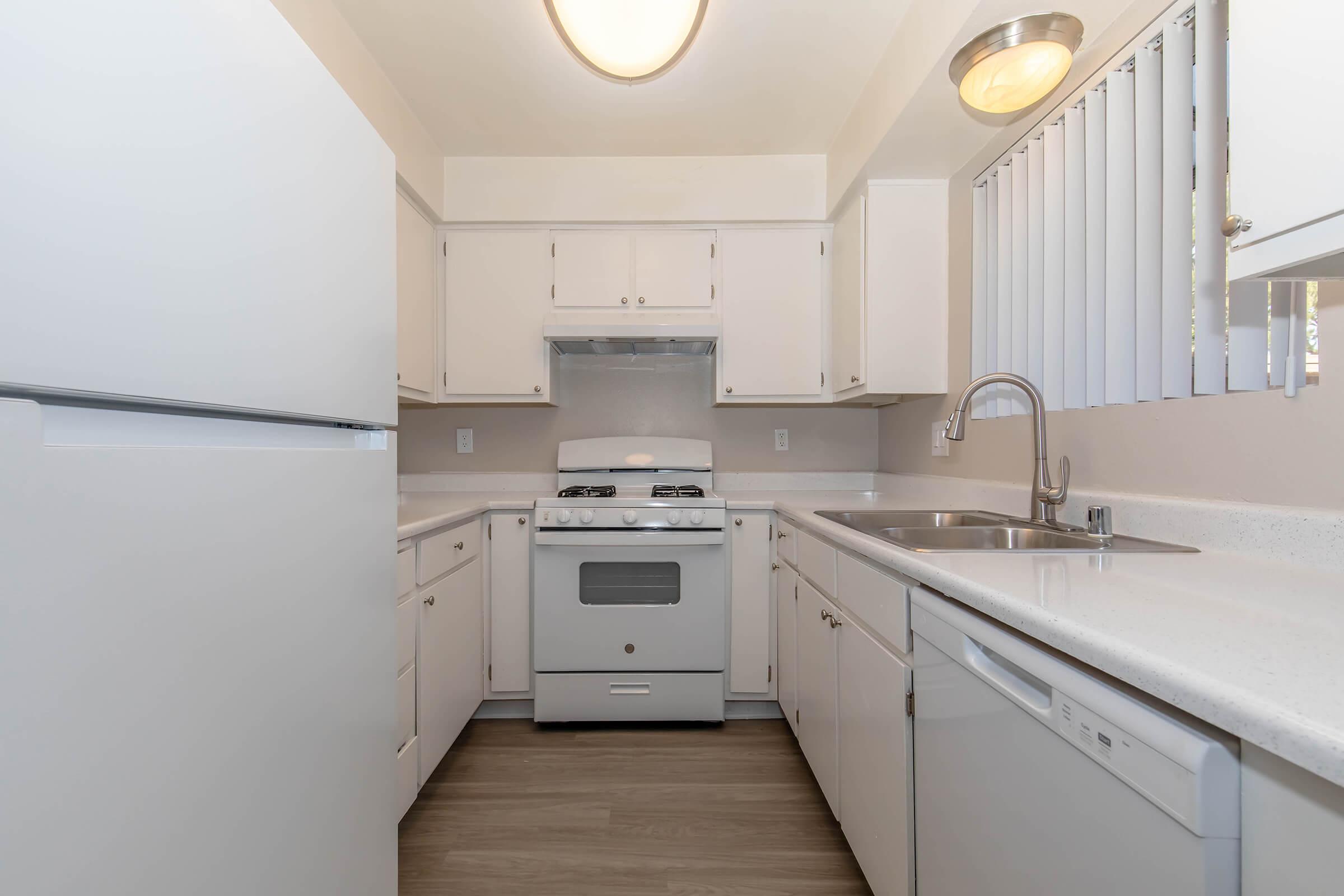 2-Bedroom Apartments in Lancaster, CA - Sienna Heights - Kitchen with White Cabinets, Chrome Hardware, and Modern Appliances