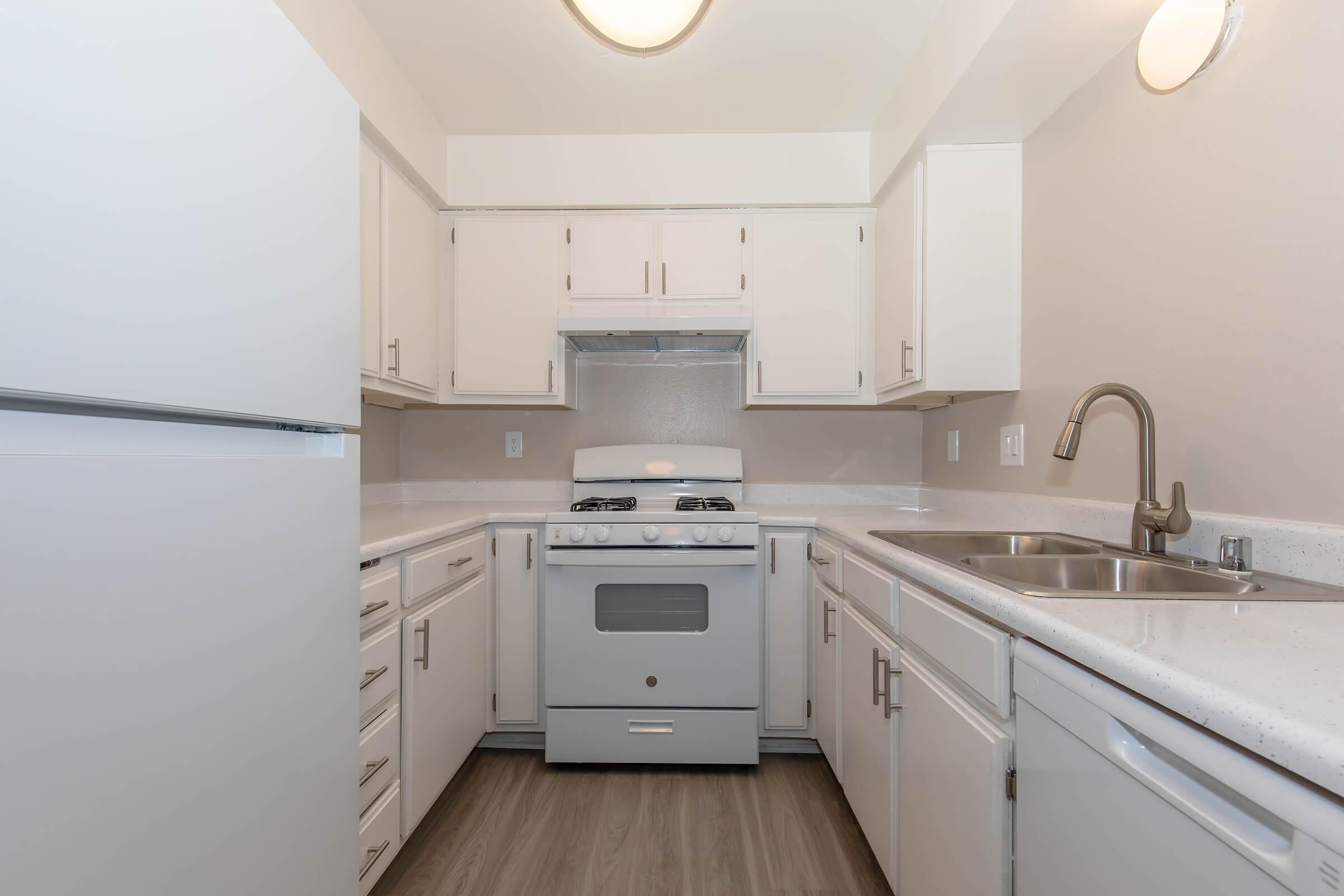 a stove top oven sitting inside of a kitchen