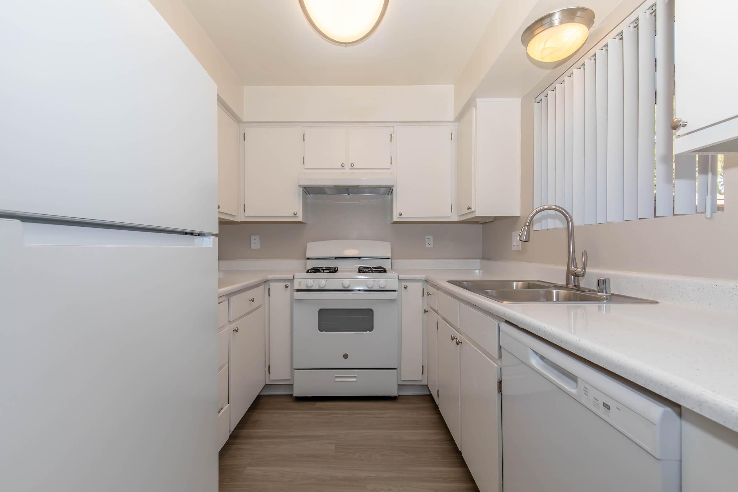 a kitchen with a stove and a refrigerator