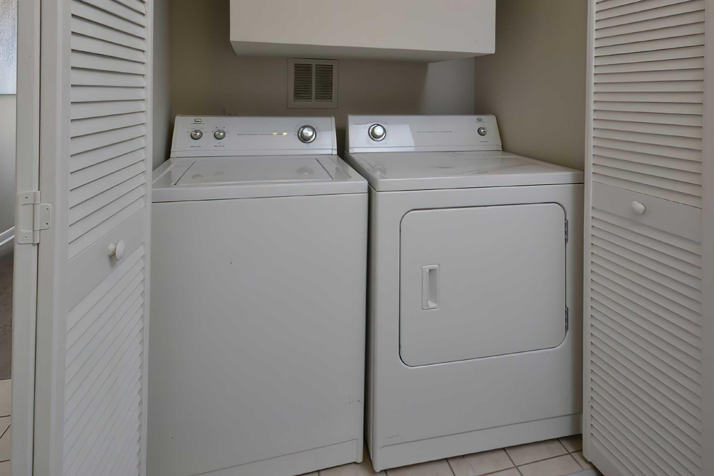 a microwave oven sitting on top of a refrigerator