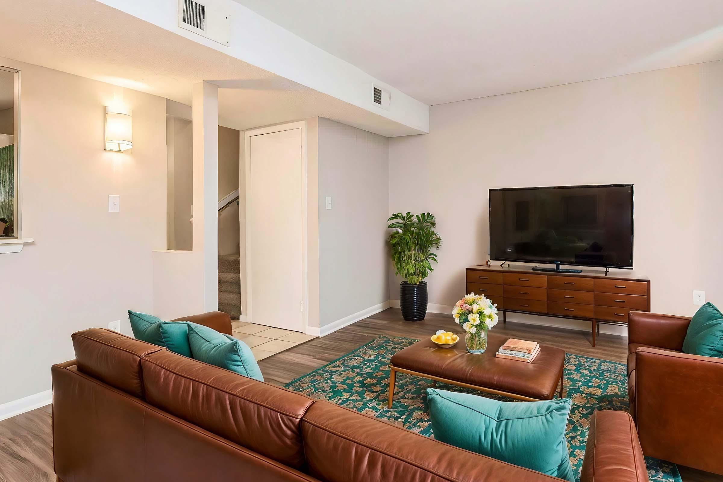 a living room filled with furniture and a flat screen tv