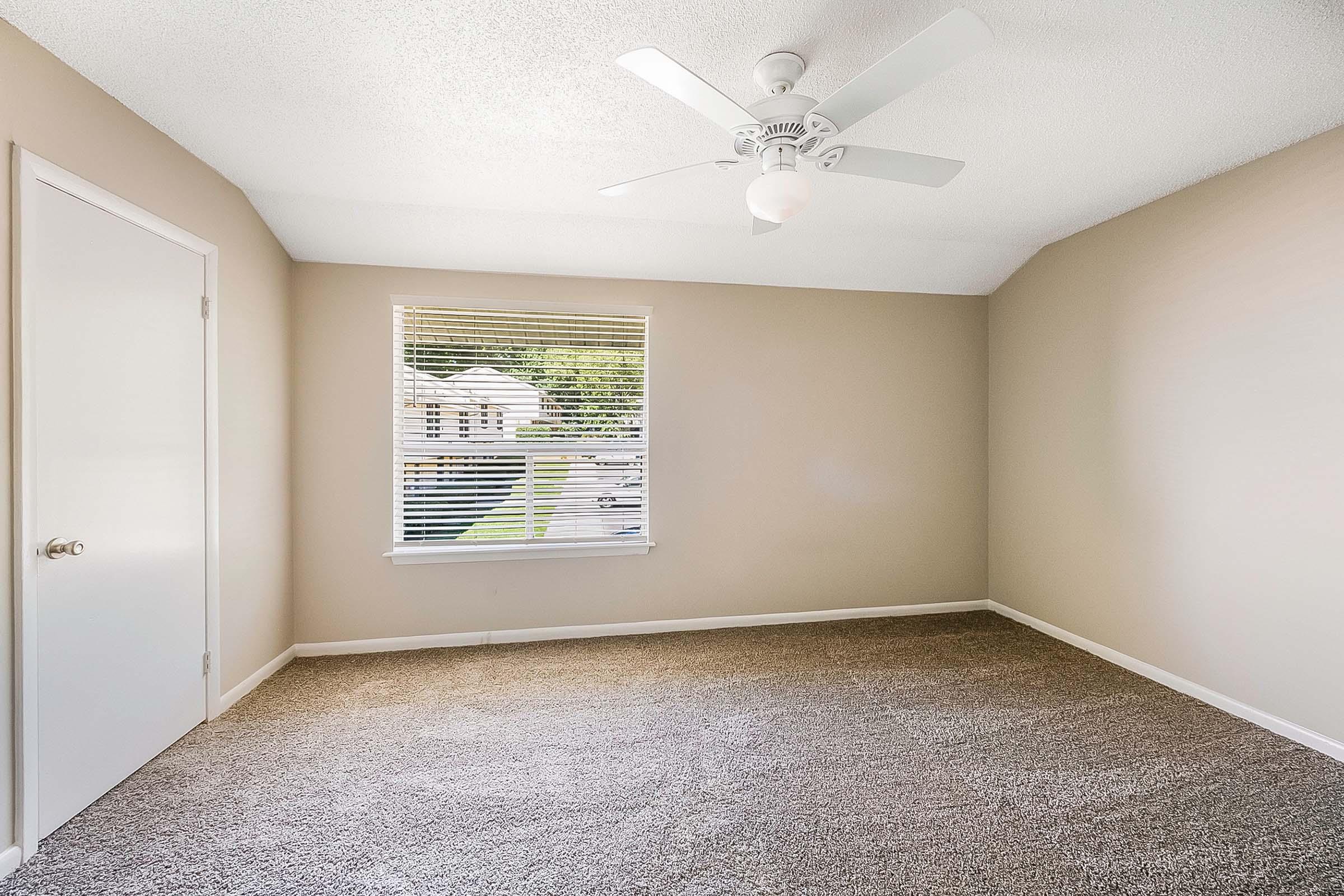 a bedroom with a large window