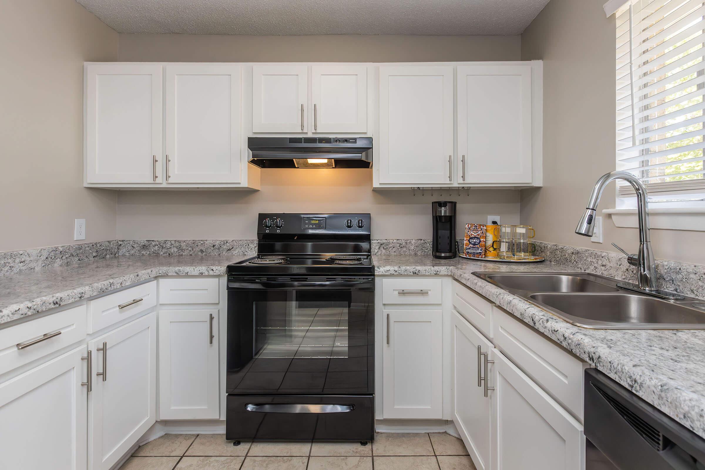 a kitchen with a stove a sink and a microwave