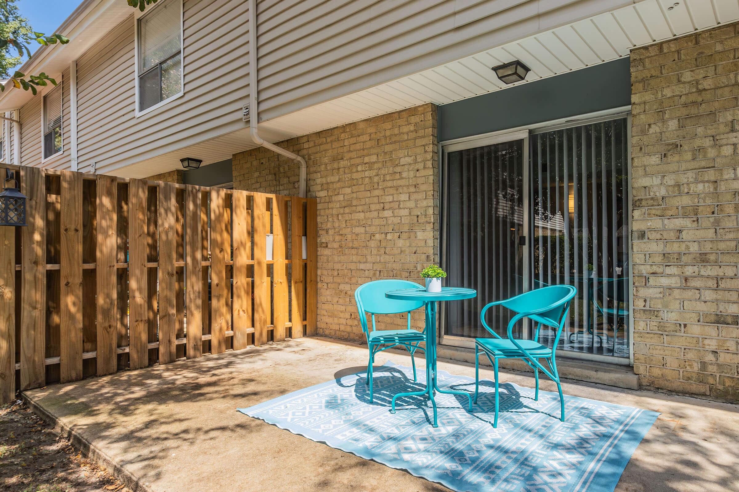 a chair sitting in front of a brick building