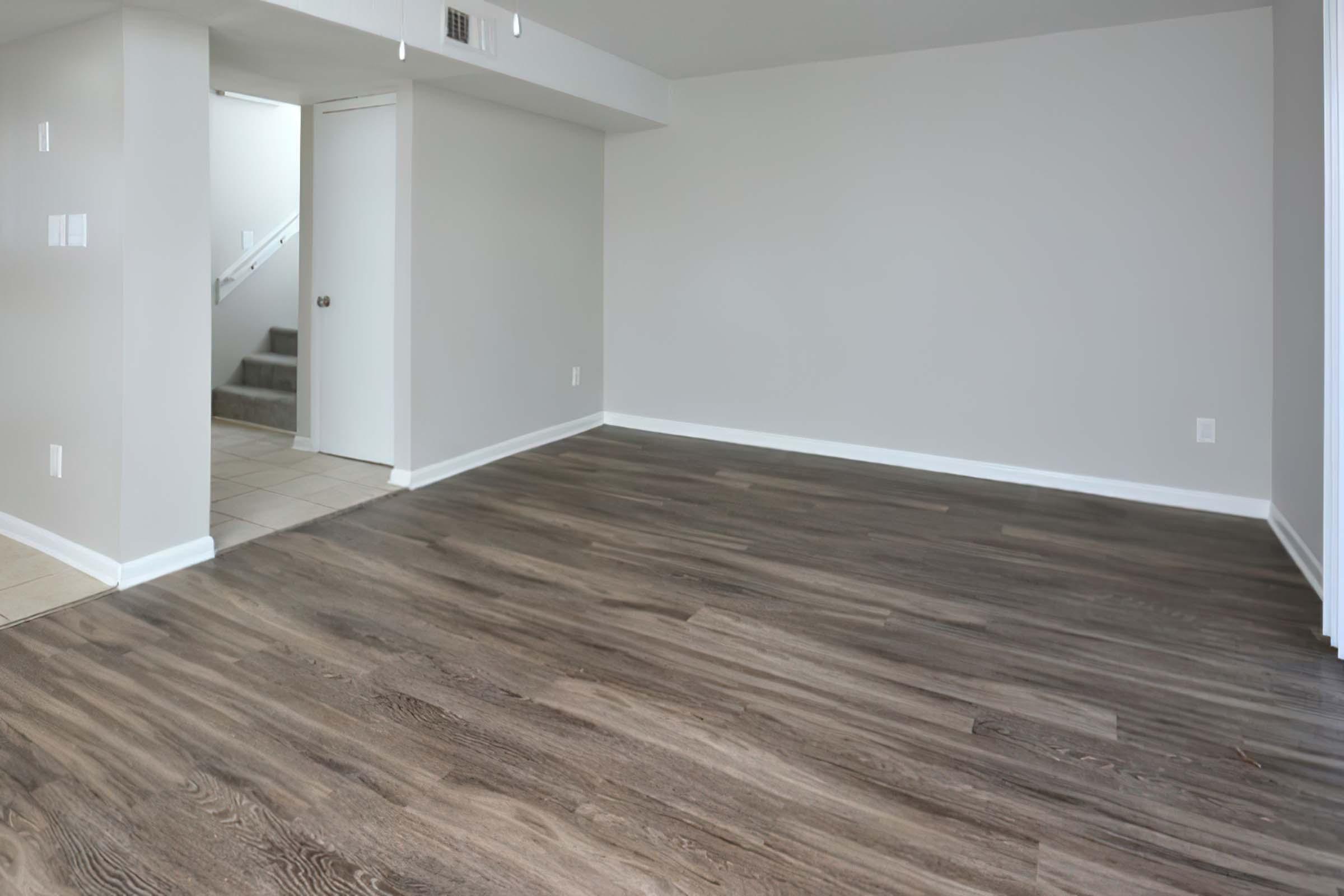 a large empty room with a wooden floor