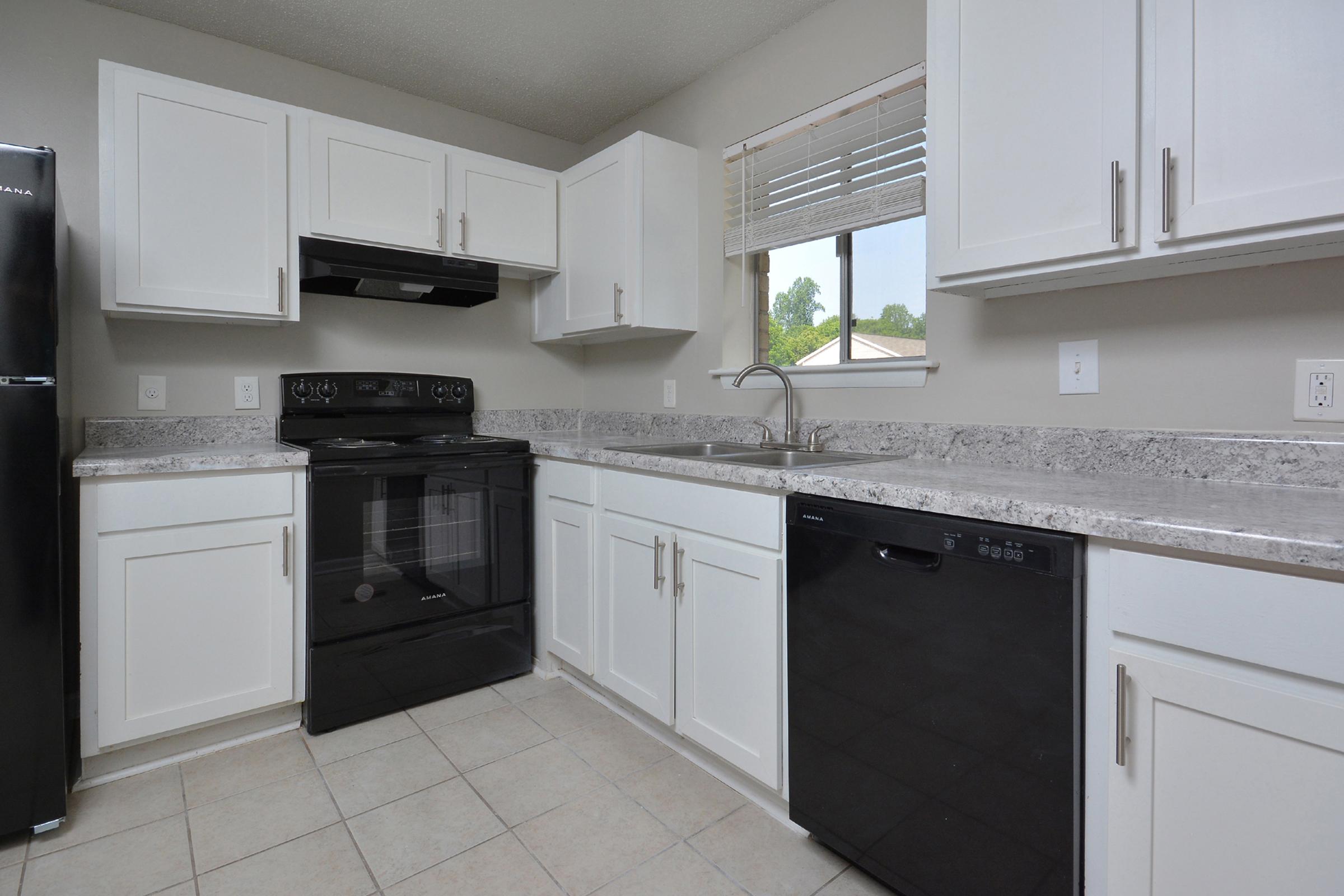 a kitchen with a stove sink and refrigerator