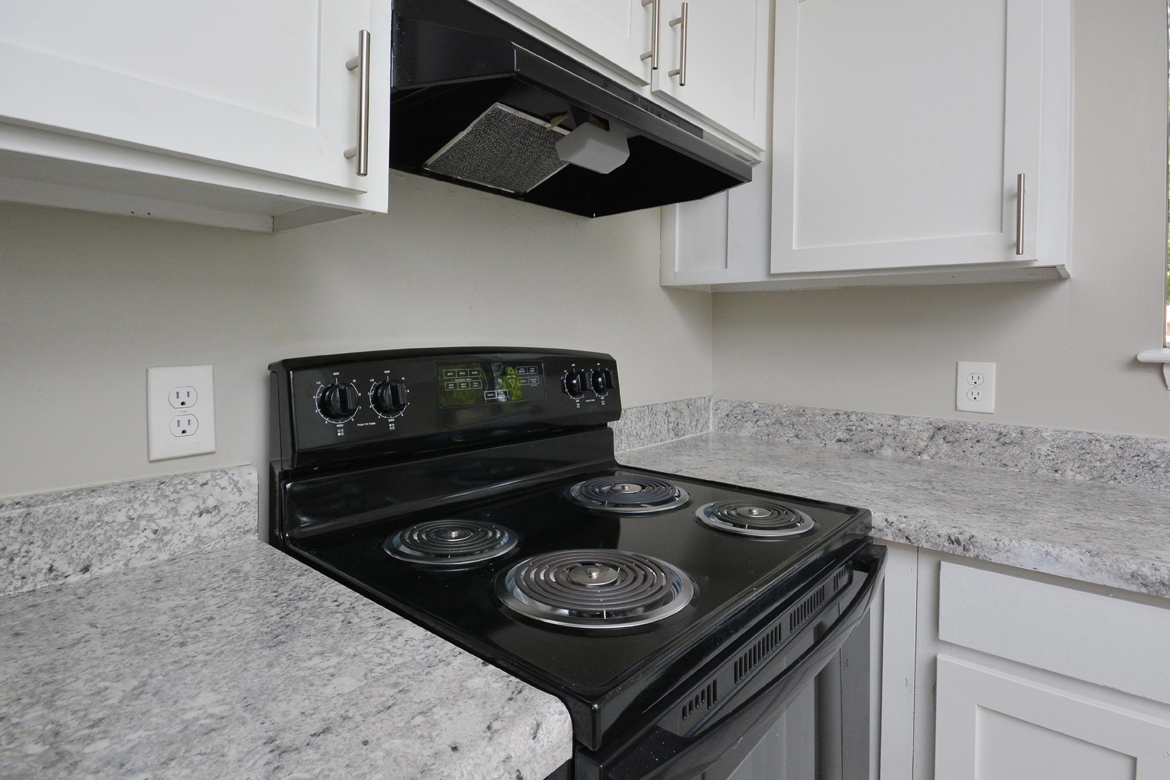 a stove top oven sitting inside of a kitchen