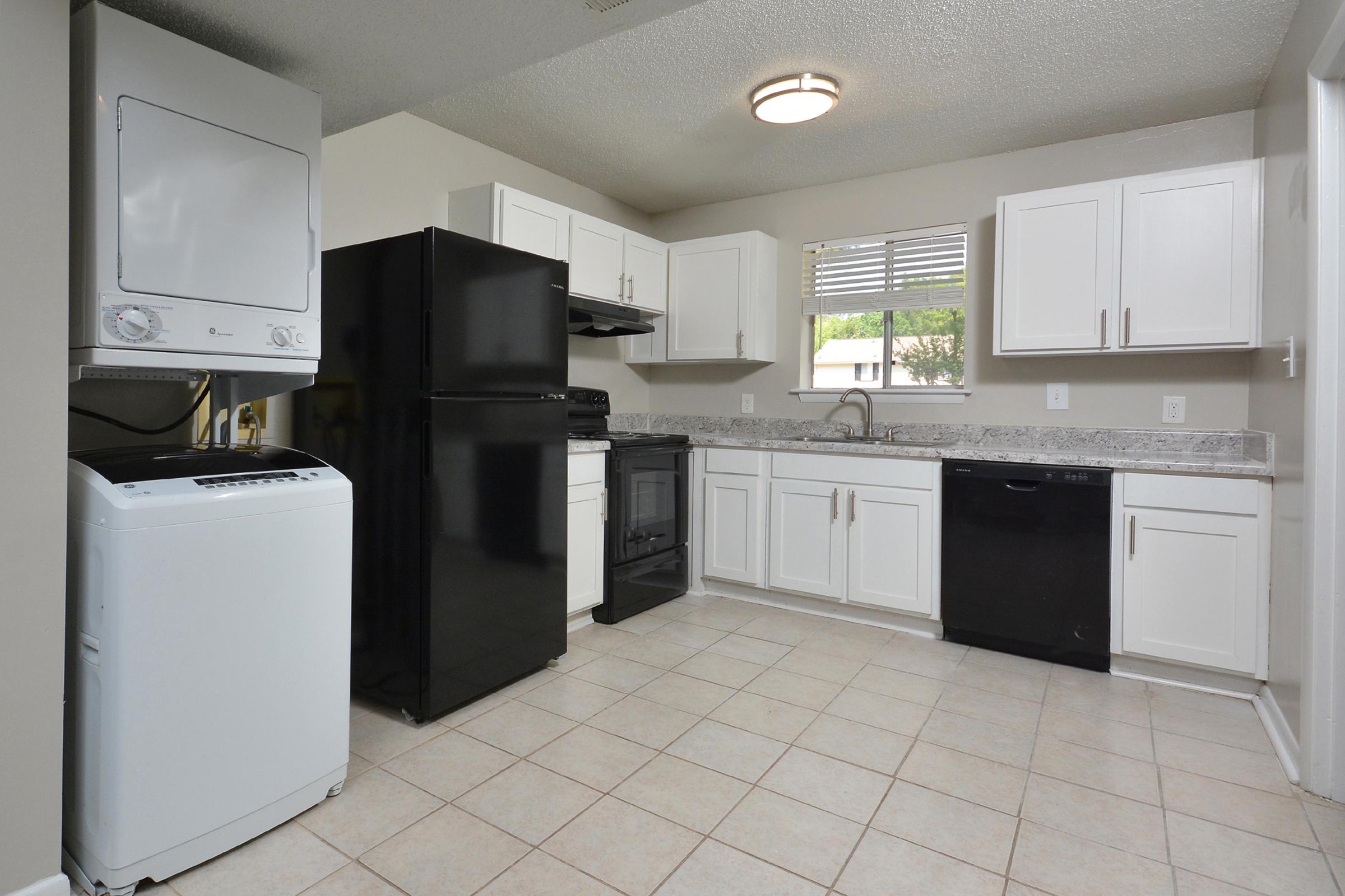 a kitchen with a stove and a refrigerator