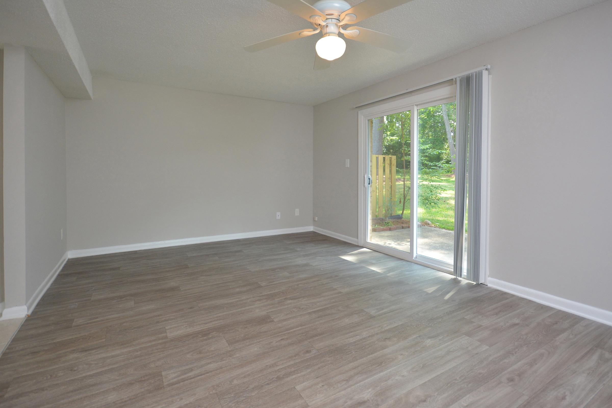 a large empty room with a wood floor