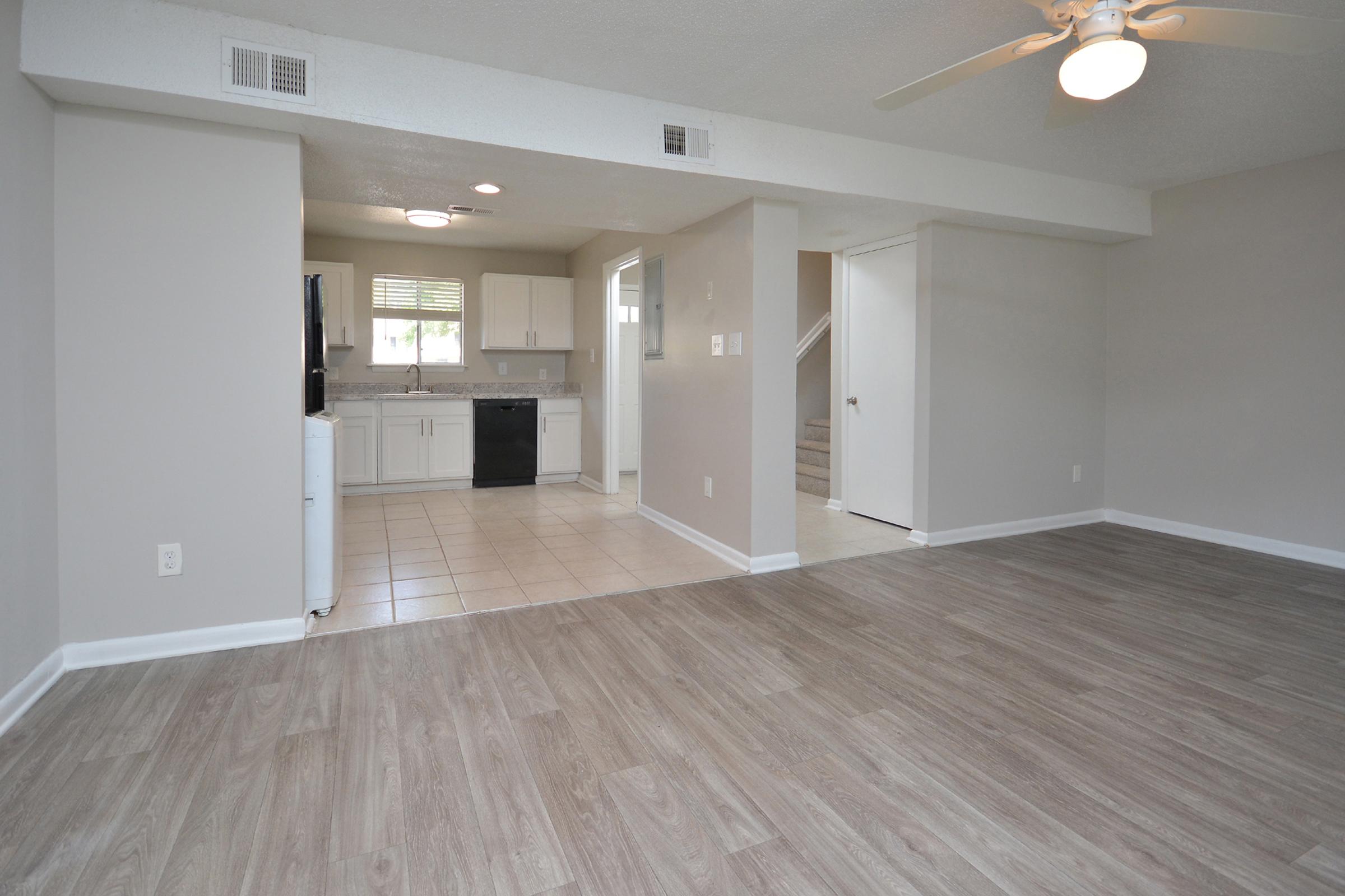 a large empty room with a wood floor