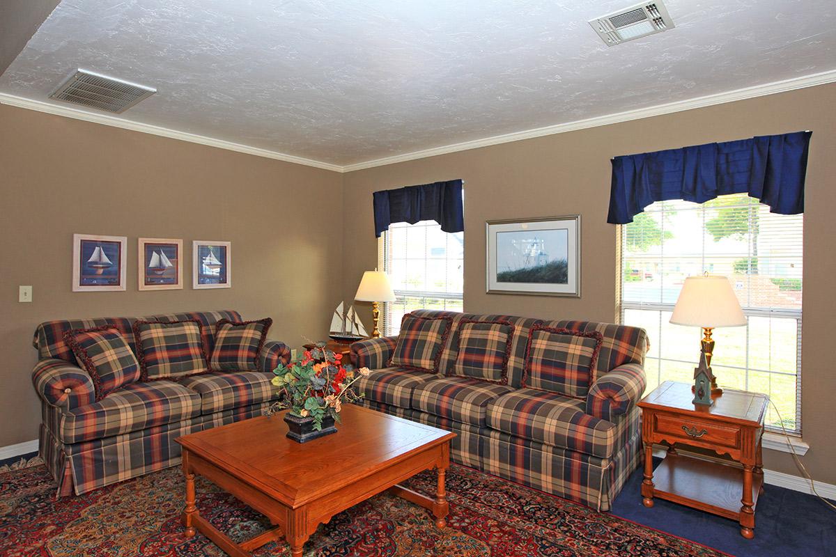 a living room filled with furniture and a flat screen tv