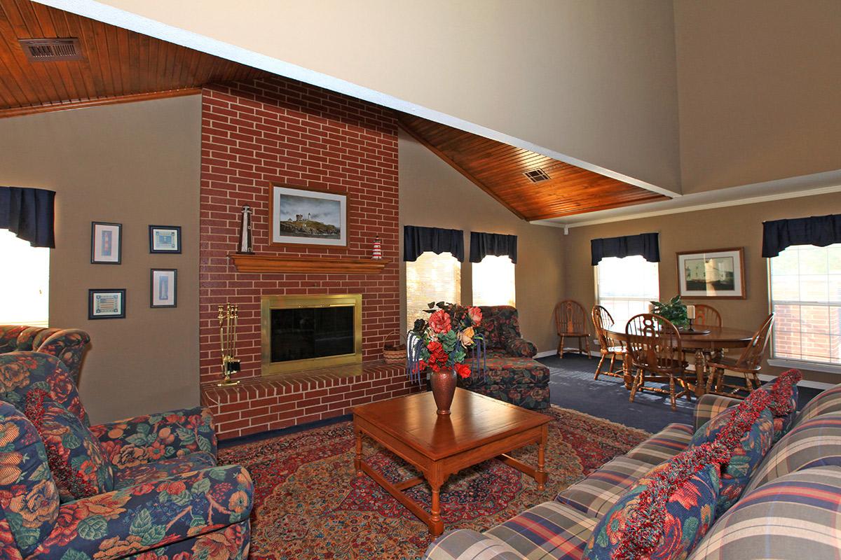 a living room filled with furniture and a fire place