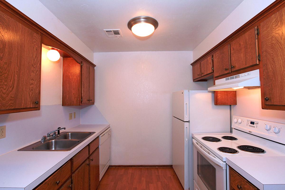 a kitchen with a stove a sink and a microwave