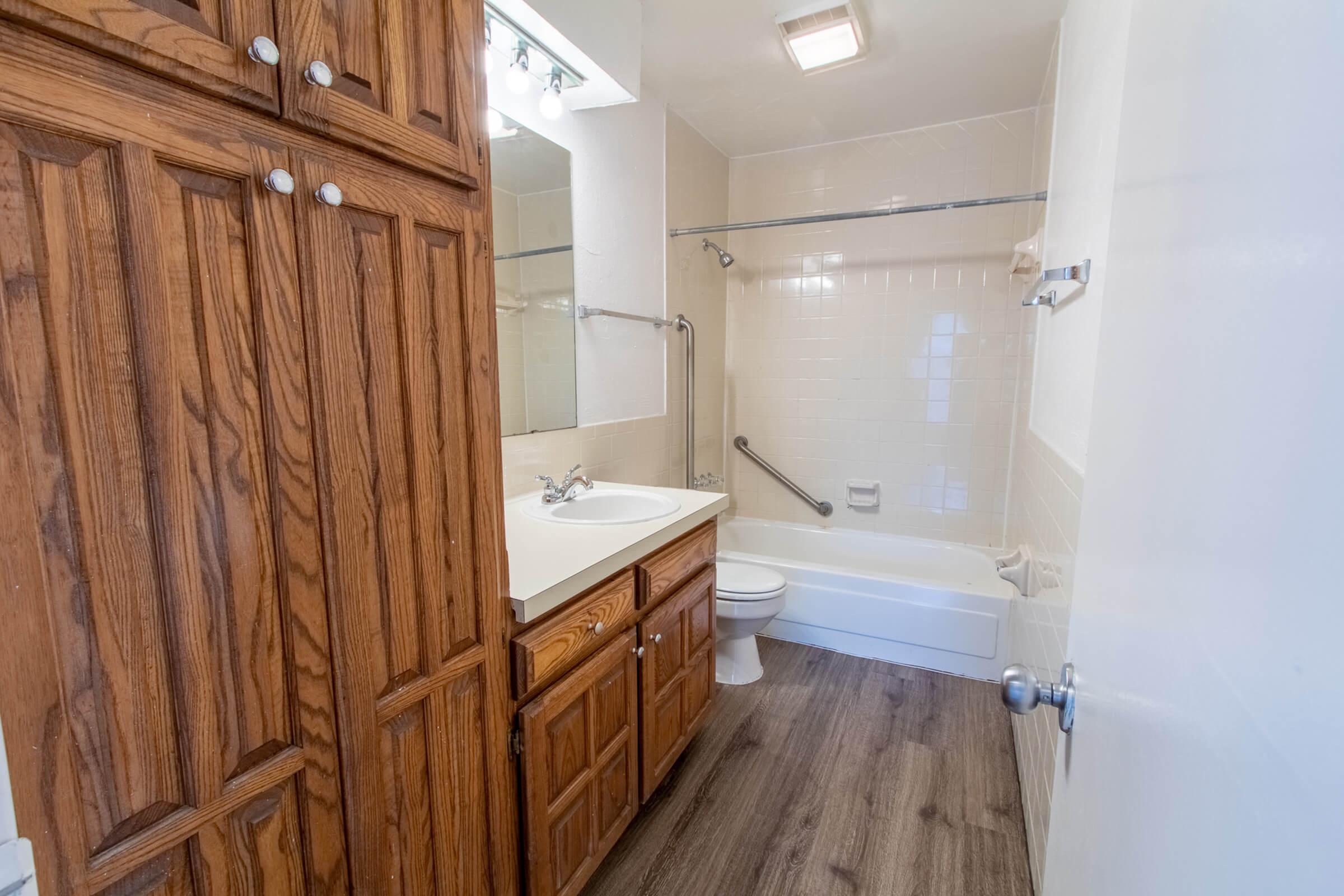 a large wooden cabinet next to a shower