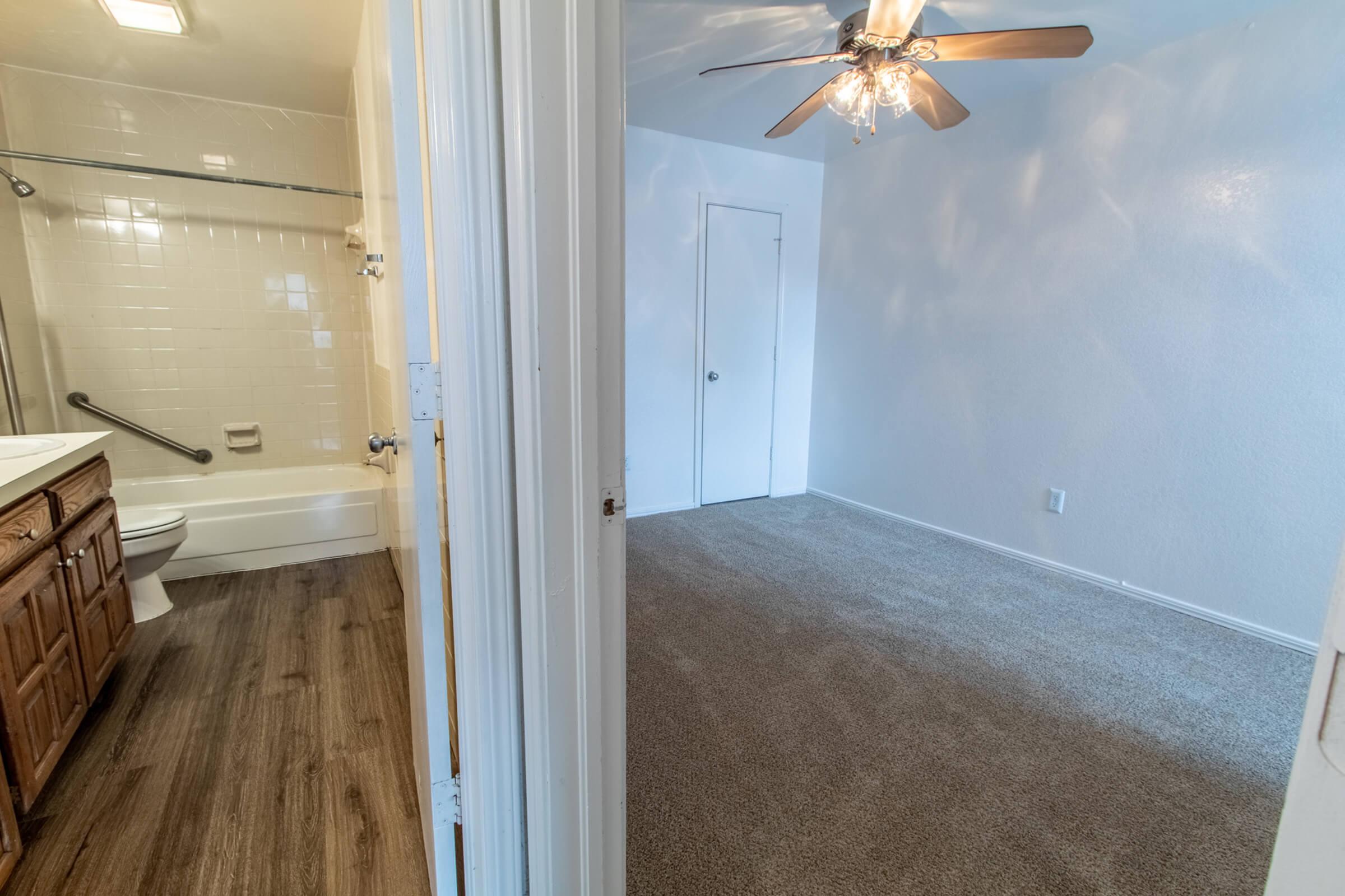 a bedroom with a wooden floor