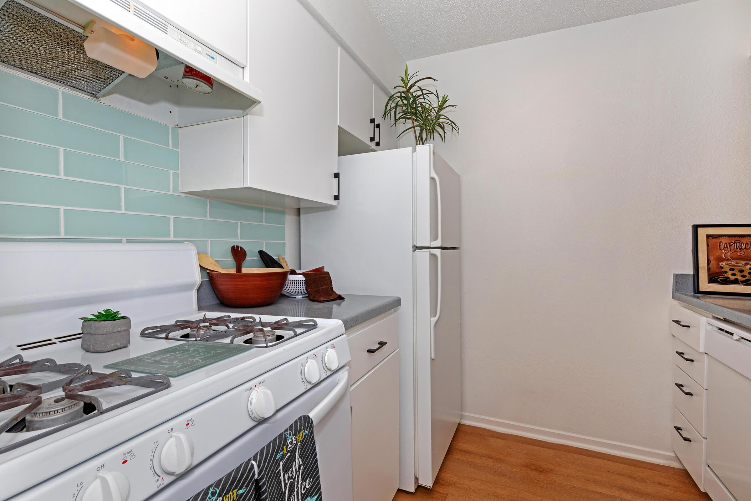 a white stove top oven sitting inside of a kitchen