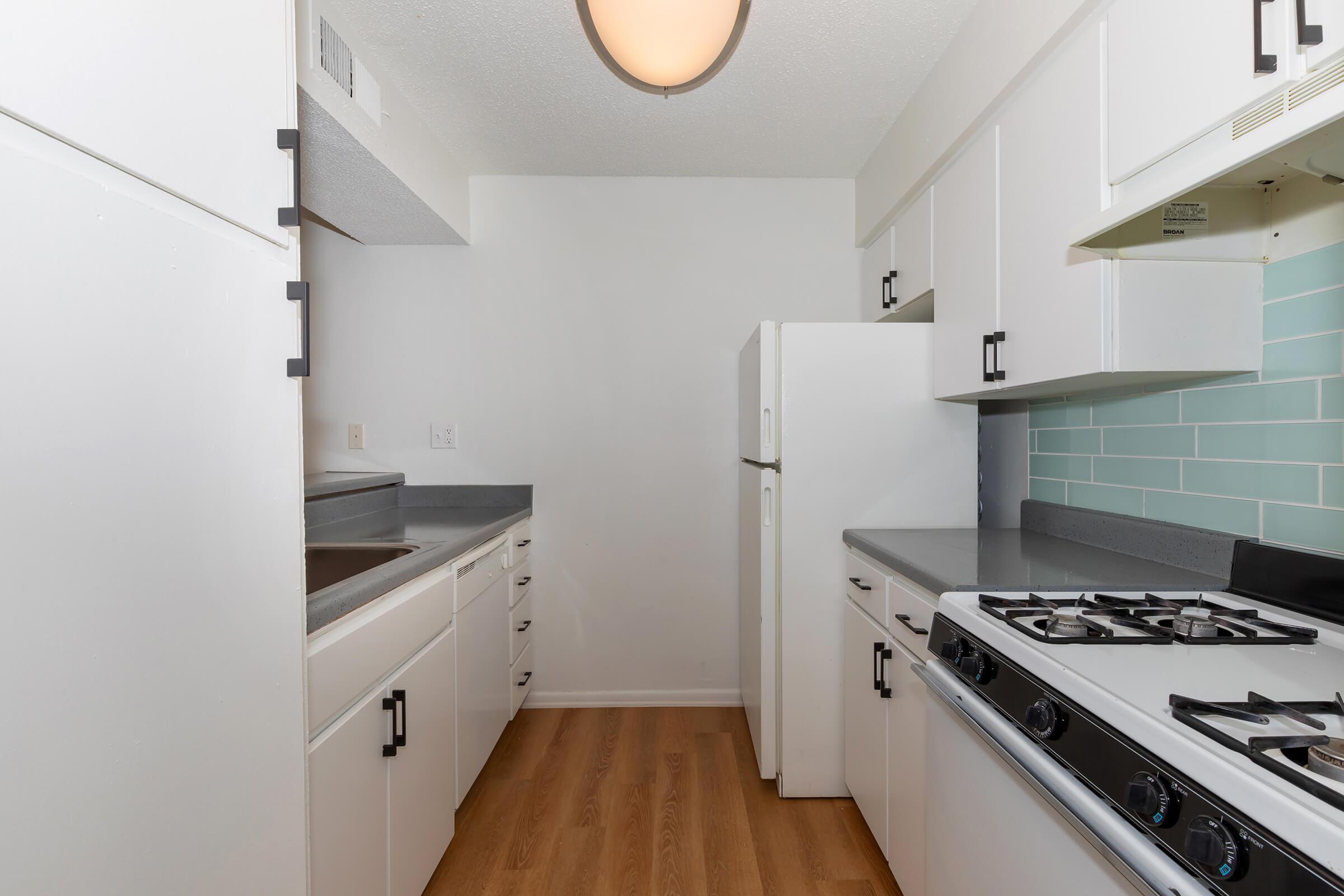 a stove top oven sitting inside of a kitchen