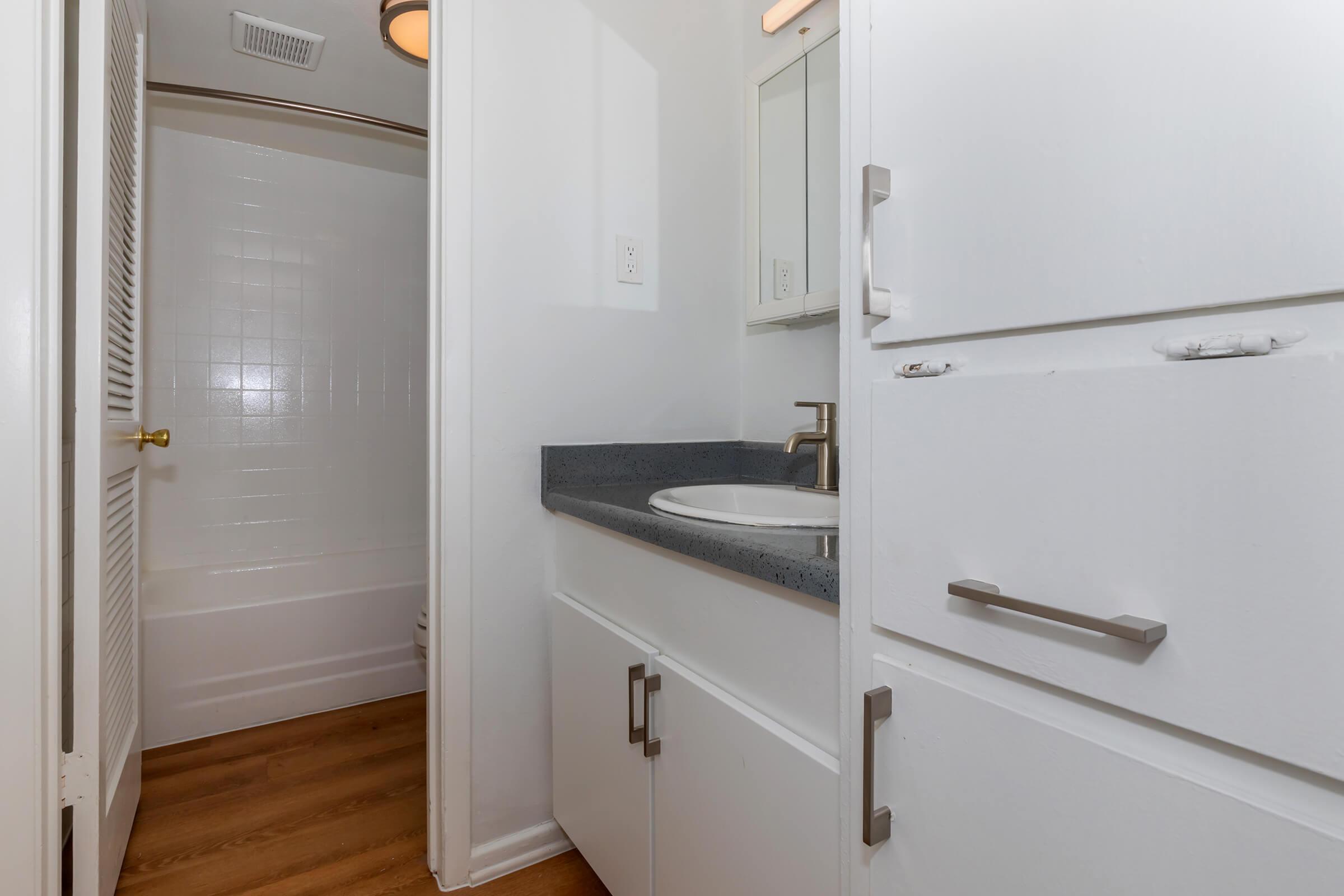 a white refrigerator freezer sitting next to a sink