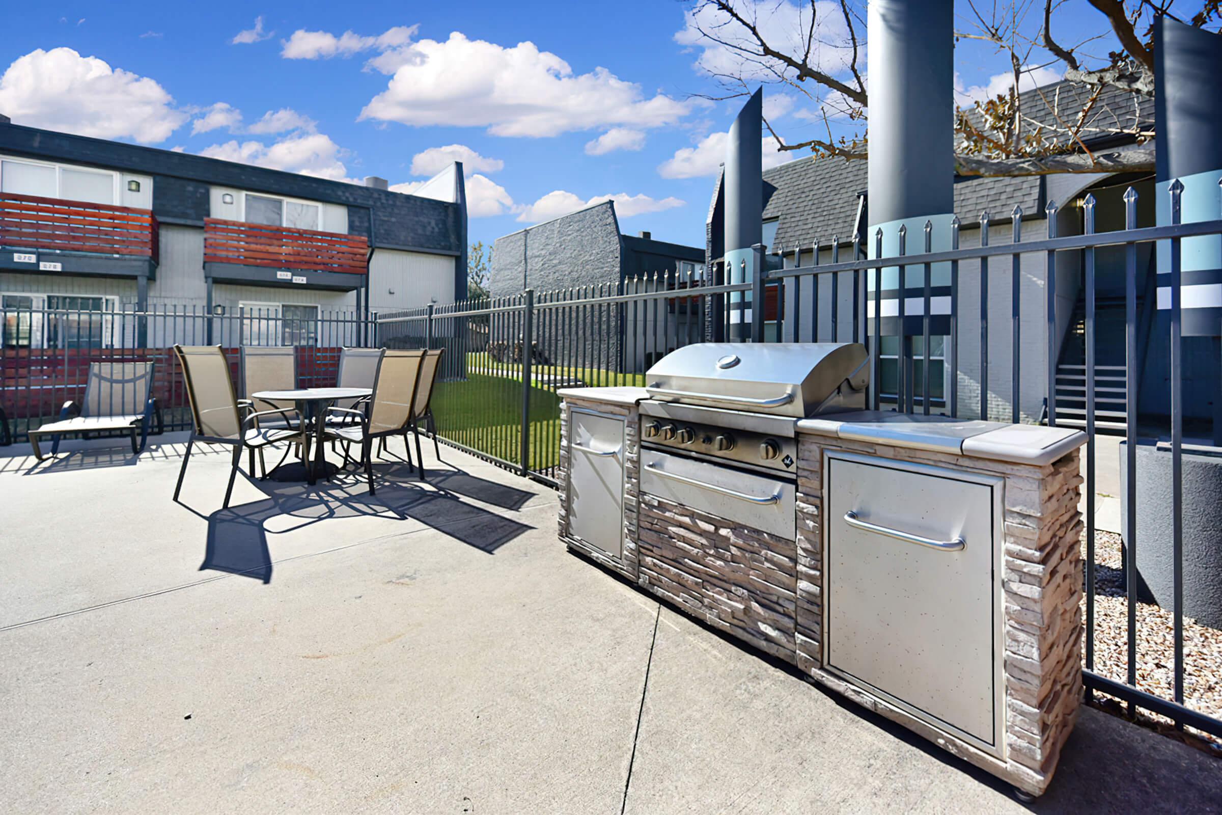 Stainless steel barbecue with a table and chairs