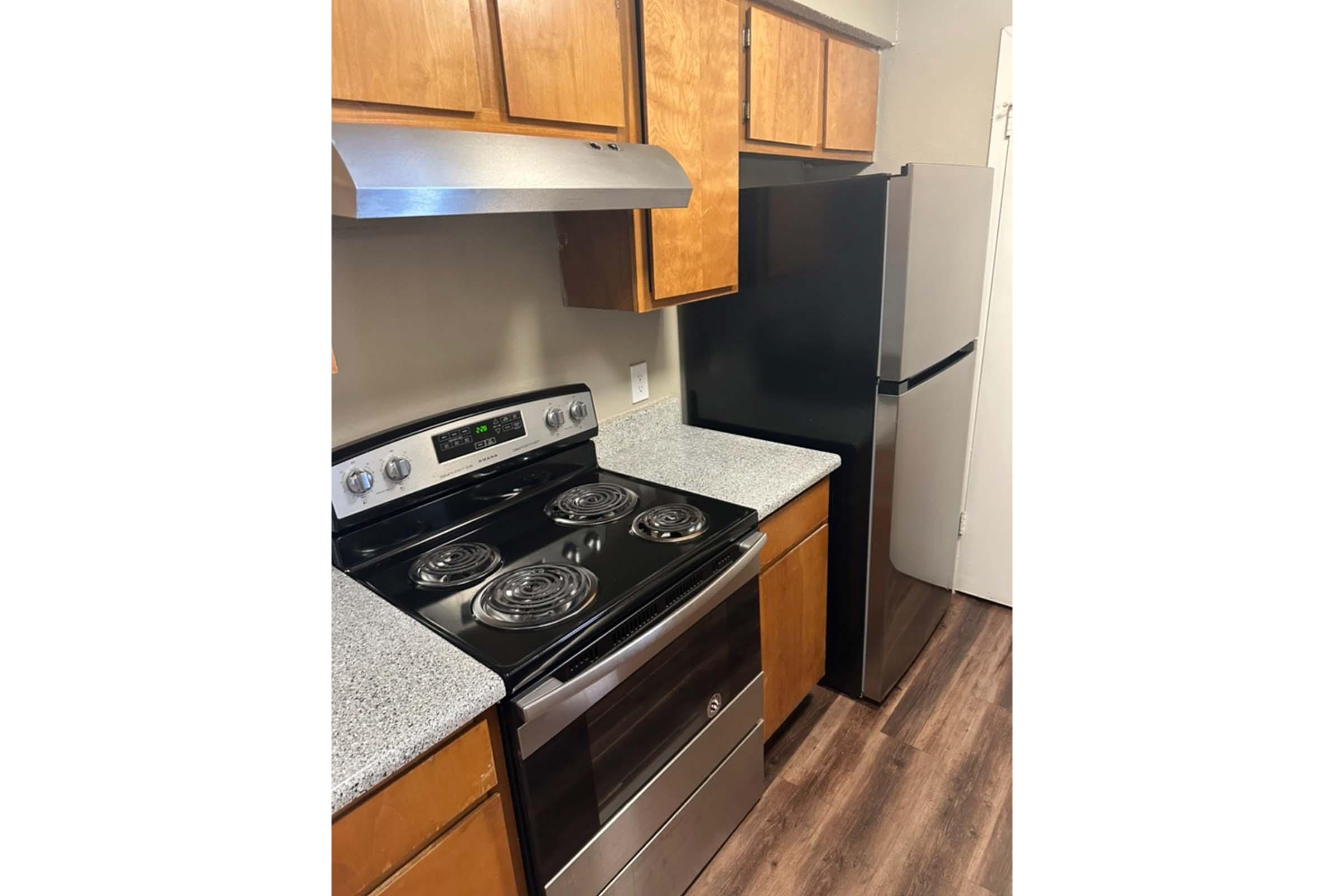 a stove top oven sitting inside of a kitchen