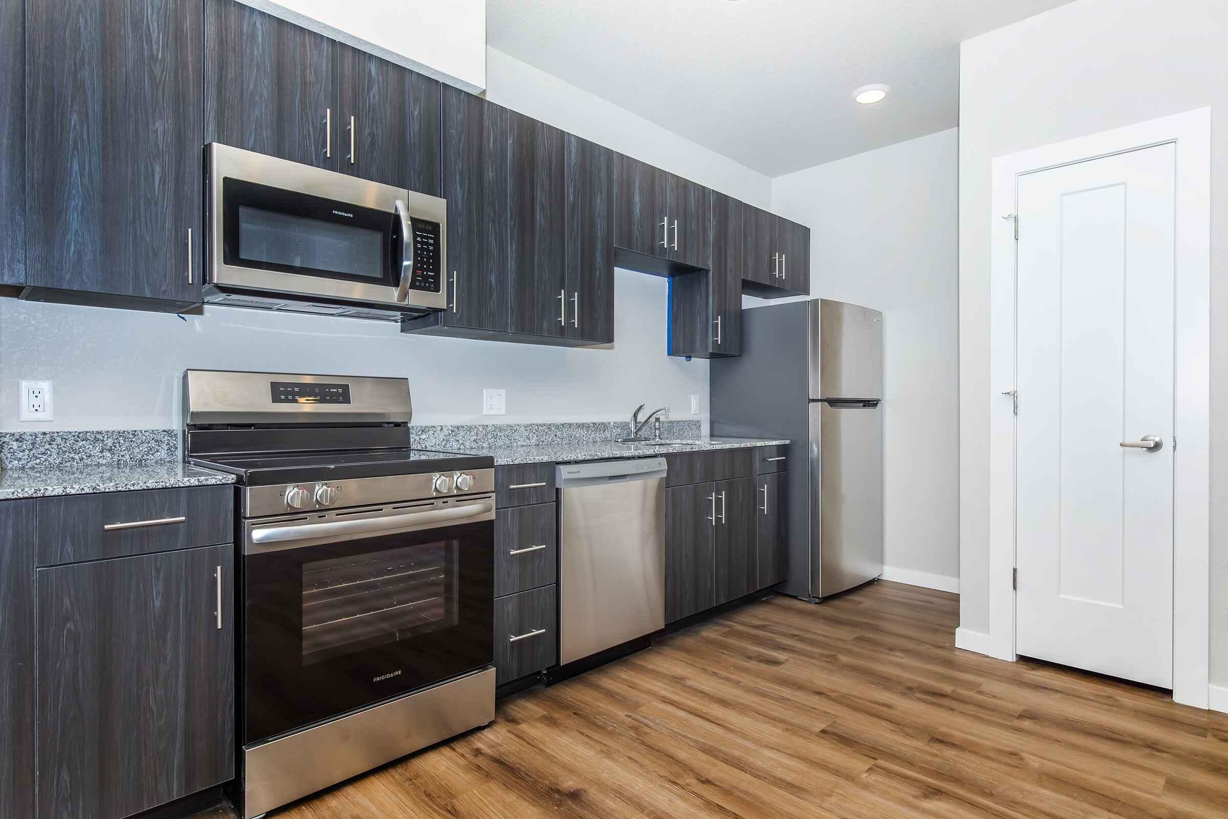 a kitchen with stainless steel appliances and wooden cabinets