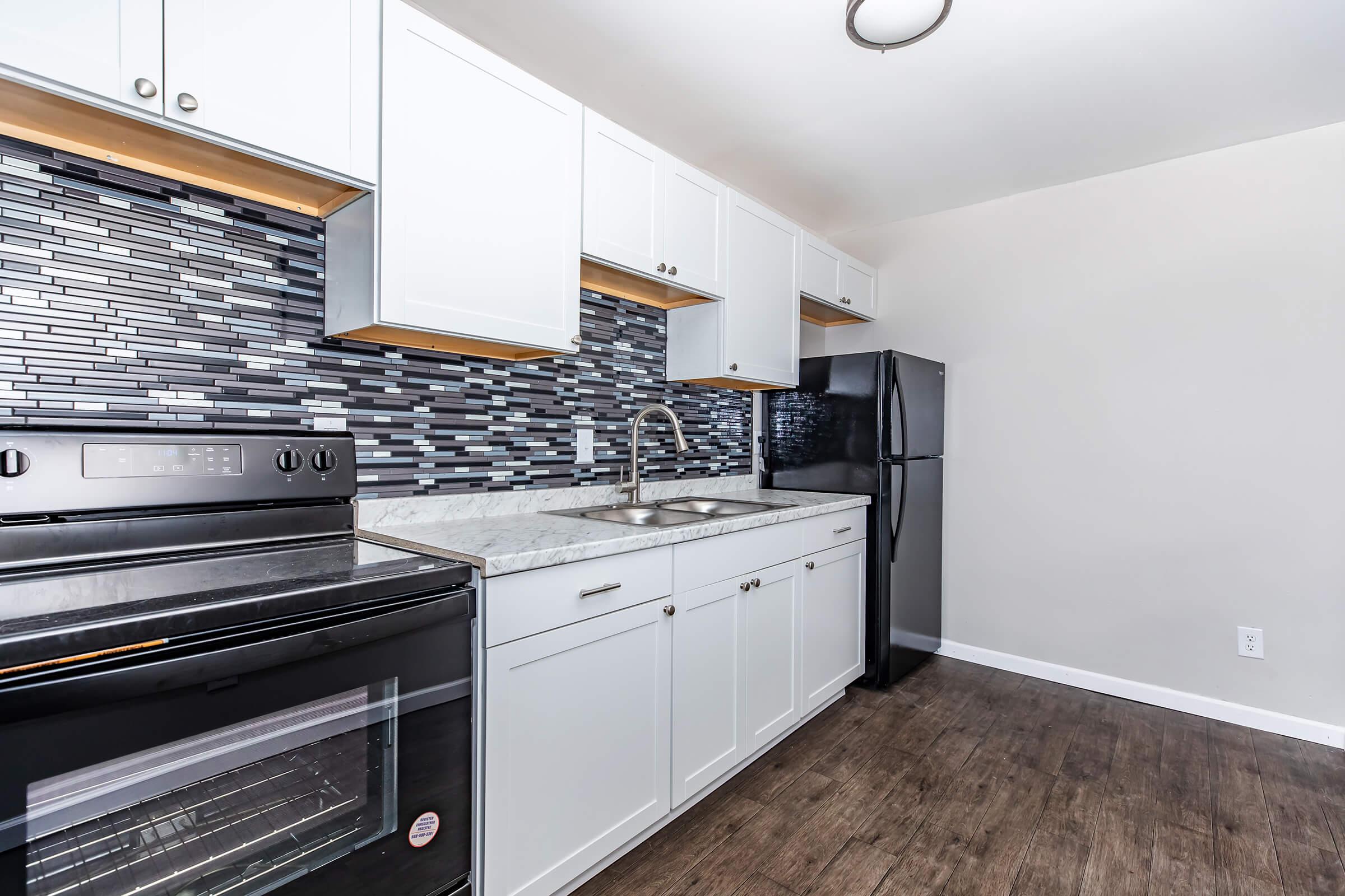 a kitchen with a stove top oven sitting inside of a building