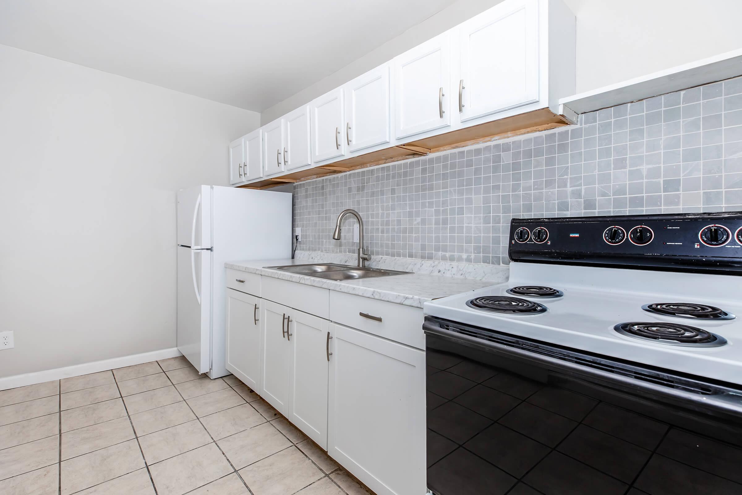 a kitchen with a tile floor