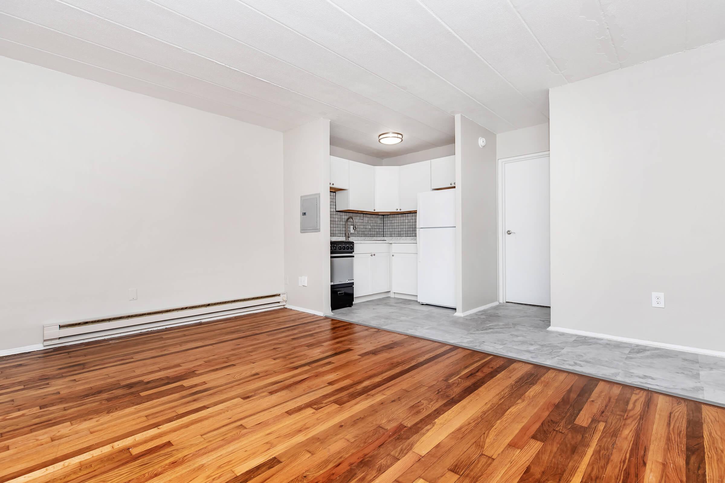 a large empty room with a wooden floor