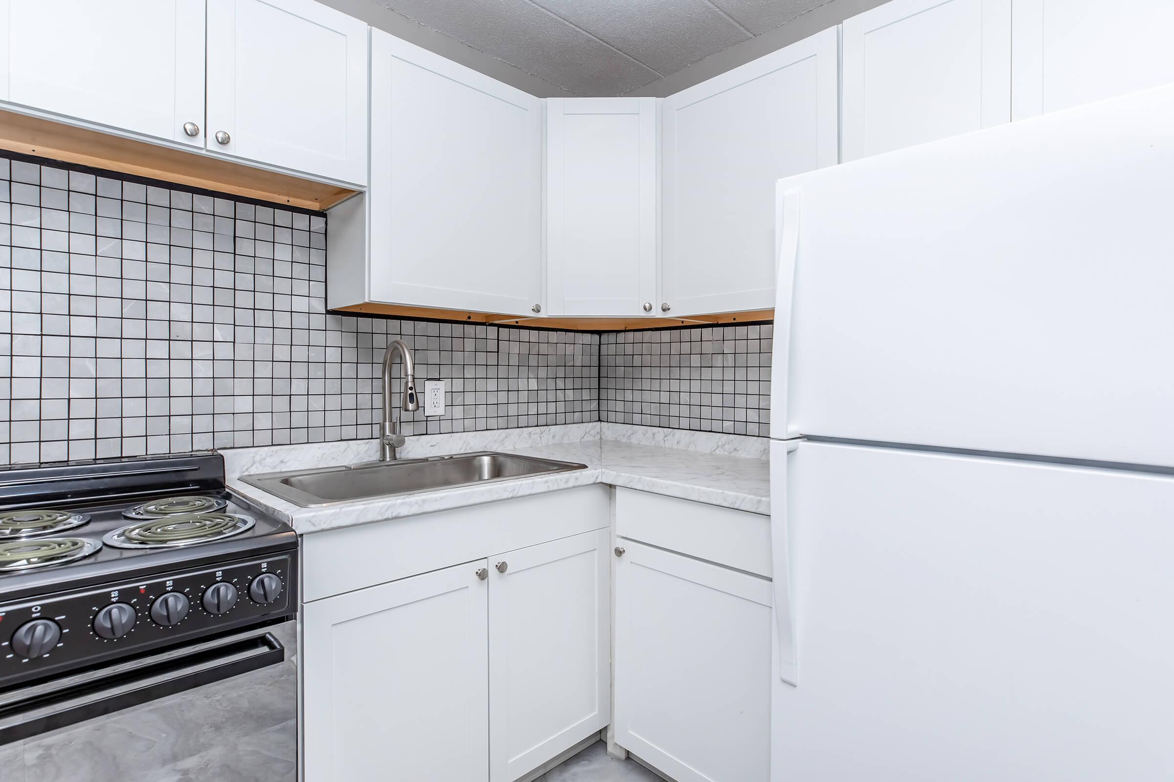 a stove top oven sitting inside of a kitchen