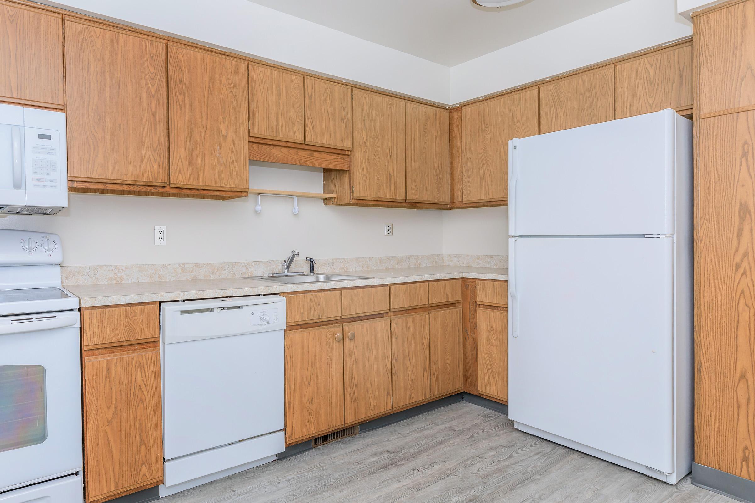 a kitchen with a stove and a refrigerator