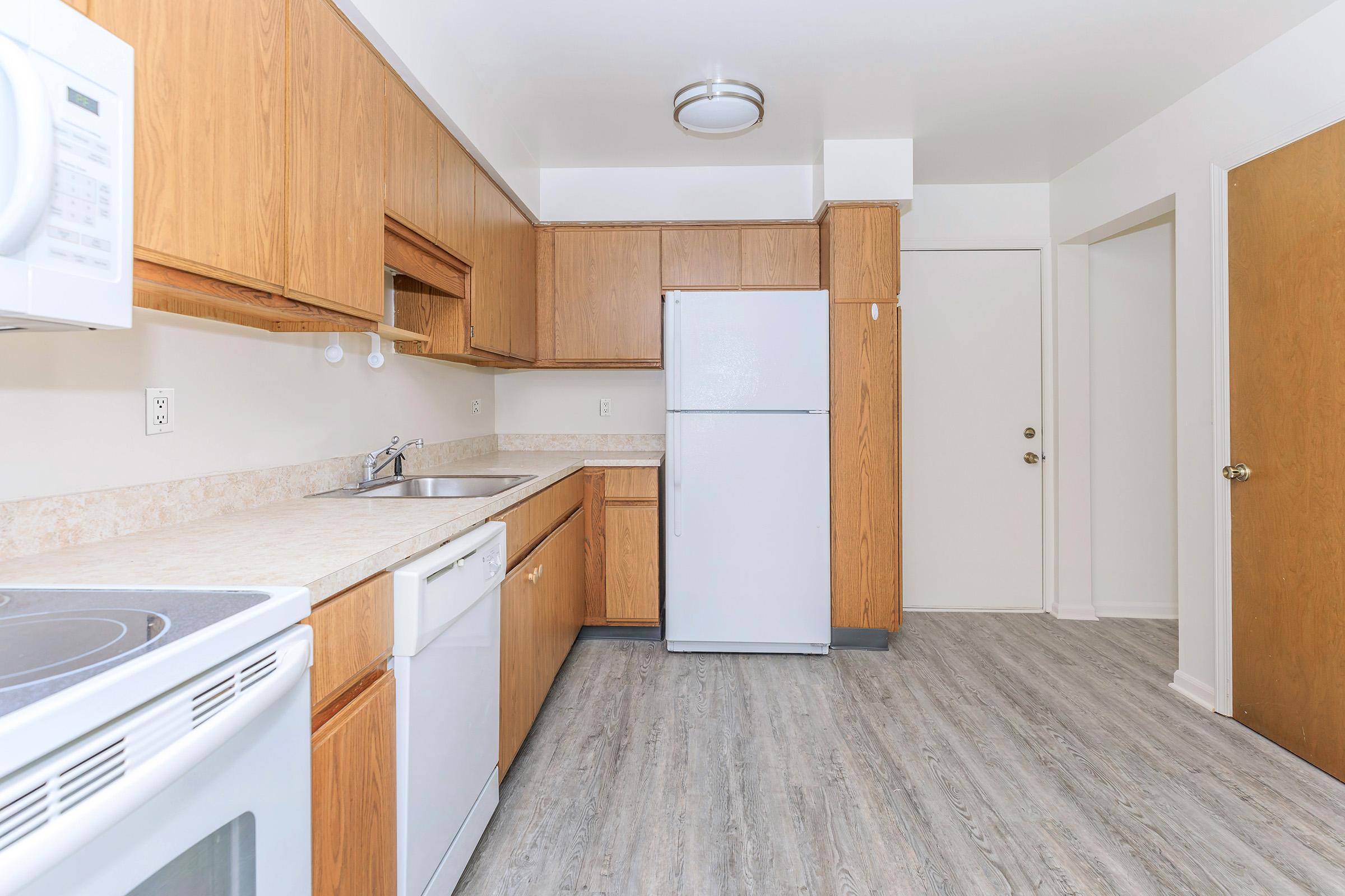 a kitchen with a stove and a refrigerator