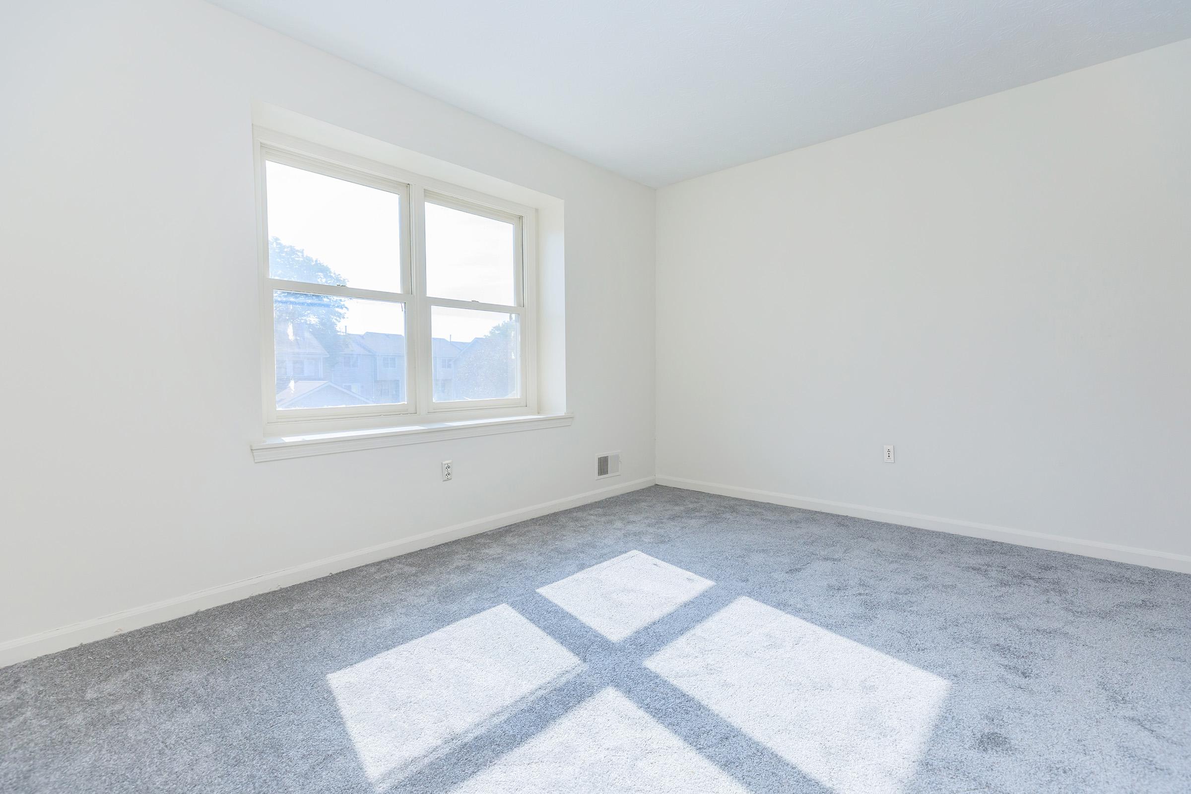 a bedroom with a large window