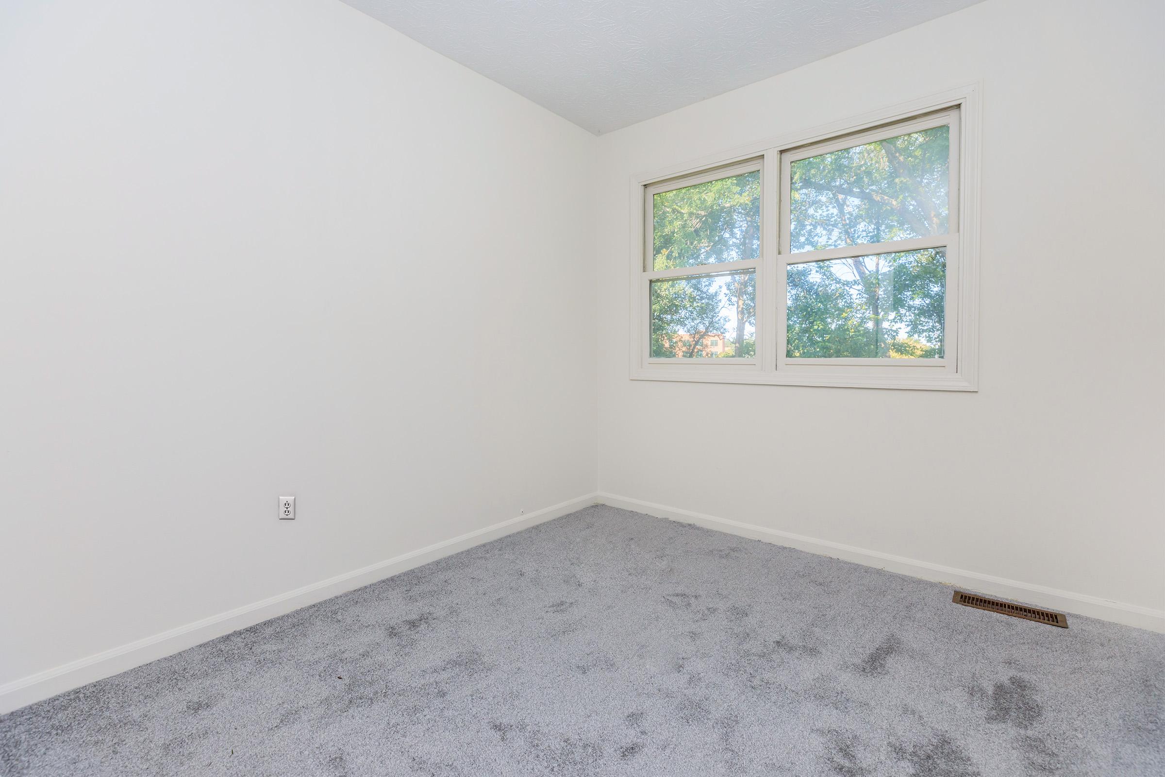 a bedroom with a large window